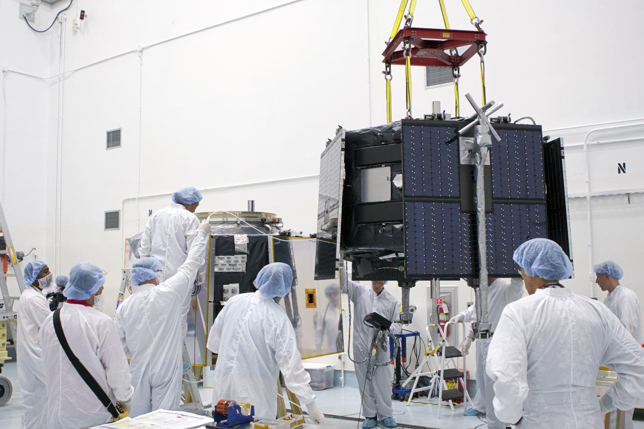 TITUSVILLE, Fla. - Inside the Astrotech payload processing facility in Titusville, Fla. near NASA’s Kennedy Space Center, technicians use a crane to move the Radiation Belt Storm Probes, or RBSP, spacecraft A into position for stacking atop RBSP B.      NASA’s RBSP mission will help us understand the sun’s influence on Earth and near-Earth space by studying the Earth’s radiation belts on various scales of space and time. RBSP will begin its mission of exploration of Earth’s Van Allen radiation belts and the extremes of space weather after its liftoff aboard a United Launch Alliance Atlas V from Space Launch Complex 41 at Cape Canaveral Air Force Station, Fla. Liftoff is targeted for Aug. 23, 2012. For more information, visit http://www.nasa.gov/rbsp. Photo credit: NASA/Jim Grossmann
