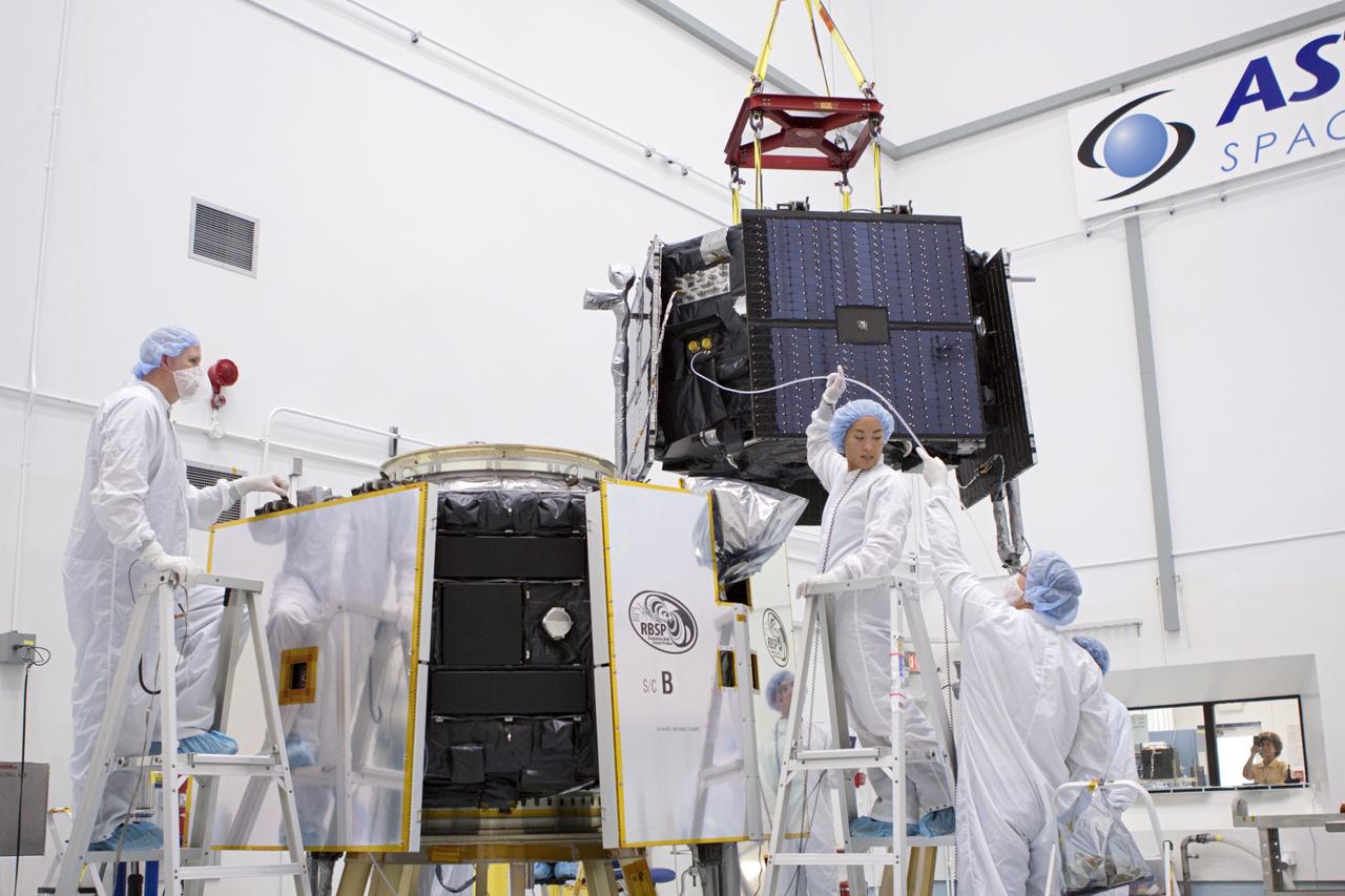 TITUSVILLE, Fla. - Inside the Astrotech payload processing facility in Titusville, Fla. near NASA’s Kennedy Space Center, technicians use a crane to move the Radiation Belt Storm Probes, or RBSP, spacecraft A into position for stacking atop RBSP B.      NASA’s RBSP mission will help us understand the sun’s influence on Earth and near-Earth space by studying the Earth’s radiation belts on various scales of space and time. RBSP will begin its mission of exploration of Earth’s Van Allen radiation belts and the extremes of space weather after its liftoff aboard a United Launch Alliance Atlas V from Space Launch Complex 41 at Cape Canaveral Air Force Station, Fla. Liftoff is targeted for Aug. 23, 2012. For more information, visit http://www.nasa.gov/rbsp. Photo credit: NASA/Jim Grossmann