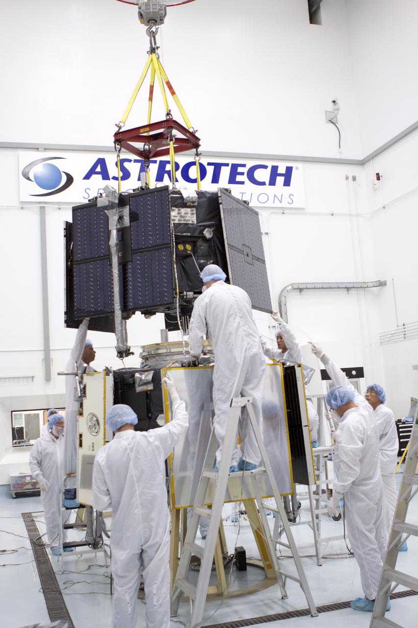 TITUSVILLE, Fla. - Inside the Astrotech payload processing facility in Titusville, Fla. near NASA’s Kennedy Space Center, technicians use a crane to move the Radiation Belt Storm Probes, or RBSP, spacecraft A into position for stacking atop RBSP B.      NASA’s RBSP mission will help us understand the sun’s influence on Earth and near-Earth space by studying the Earth’s radiation belts on various scales of space and time. RBSP will begin its mission of exploration of Earth’s Van Allen radiation belts and the extremes of space weather after its liftoff aboard a United Launch Alliance Atlas V from Space Launch Complex 41 at Cape Canaveral Air Force Station, Fla. Liftoff is targeted for Aug. 23, 2012. For more information, visit http://www.nasa.gov/rbsp. Photo credit: NASA/Jim Grossmann