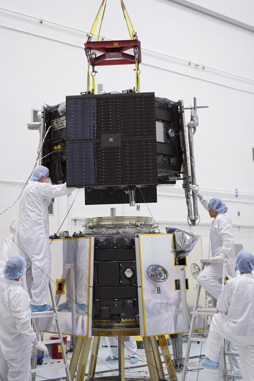 TITUSVILLE, Fla. - Inside the Astrotech payload processing facility in Titusville, Fla. near NASA’s Kennedy Space Center, technicians use a crane to position the Radiation Belt Storm Probes, or RBSP, spacecraft A for stacking atop RBSP B.      NASA’s RBSP mission will help us understand the sun’s influence on Earth and near-Earth space by studying the Earth’s radiation belts on various scales of space and time. RBSP will begin its mission of exploration of Earth’s Van Allen radiation belts and the extremes of space weather after its liftoff aboard a United Launch Alliance Atlas V from Space Launch Complex 41 at Cape Canaveral Air Force Station, Fla. Liftoff is targeted for Aug. 23, 2012. For more information, visit http://www.nasa.gov/rbsp. Photo credit: NASA/Jim Grossmann