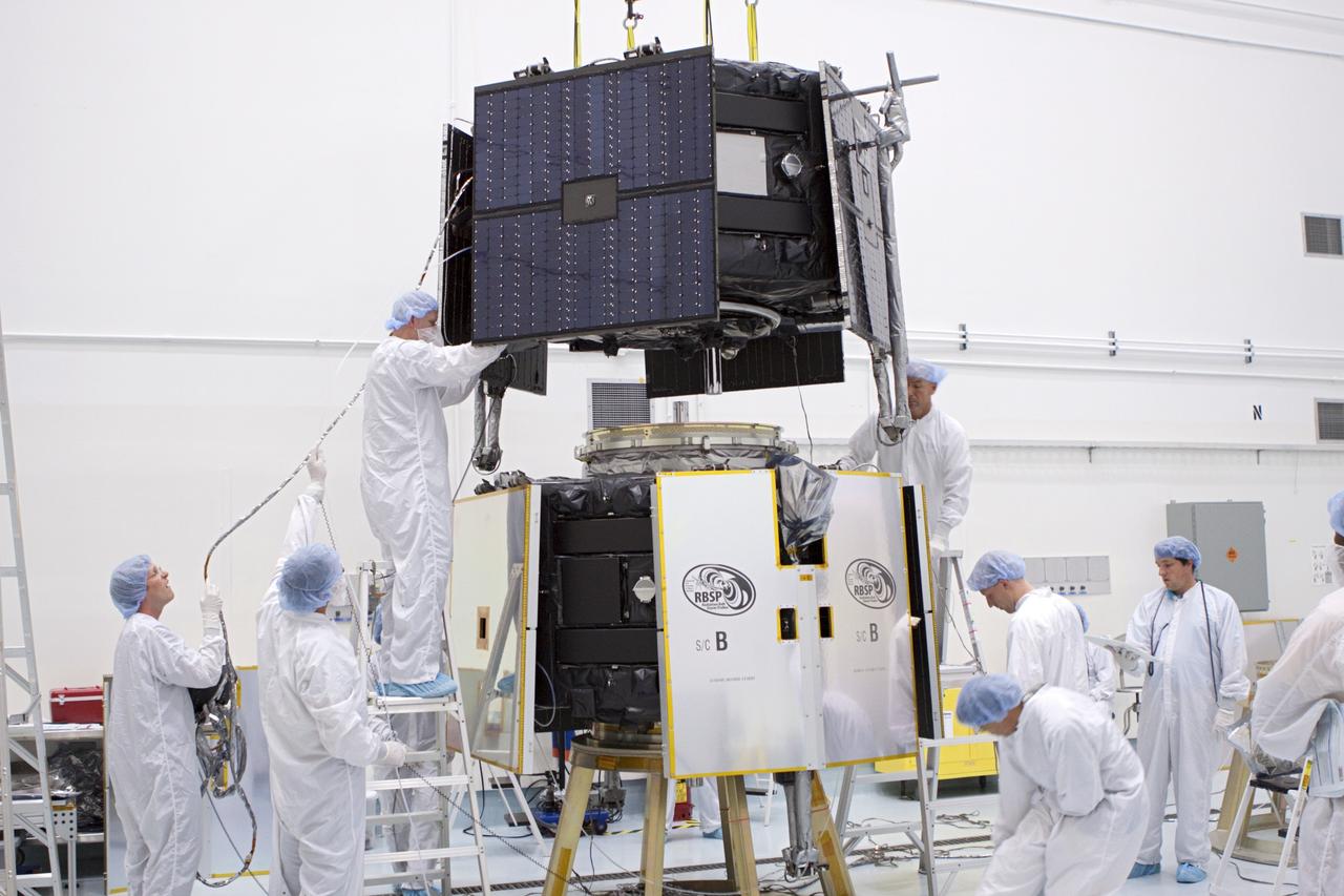 TITUSVILLE, Fla. - Inside the Astrotech payload processing facility in Titusville, Fla. near NASA’s Kennedy Space Center, technicians use a crane to position the Radiation Belt Storm Probes, or RBSP, spacecraft A for stacking atop RBSP B.      NASA’s RBSP mission will help us understand the sun’s influence on Earth and near-Earth space by studying the Earth’s radiation belts on various scales of space and time. RBSP will begin its mission of exploration of Earth’s Van Allen radiation belts and the extremes of space weather after its liftoff aboard a United Launch Alliance Atlas V from Space Launch Complex 41 at Cape Canaveral Air Force Station, Fla. Liftoff is targeted for Aug. 23, 2012. For more information, visit http://www.nasa.gov/rbsp. Photo credit: NASA/Jim Grossmann