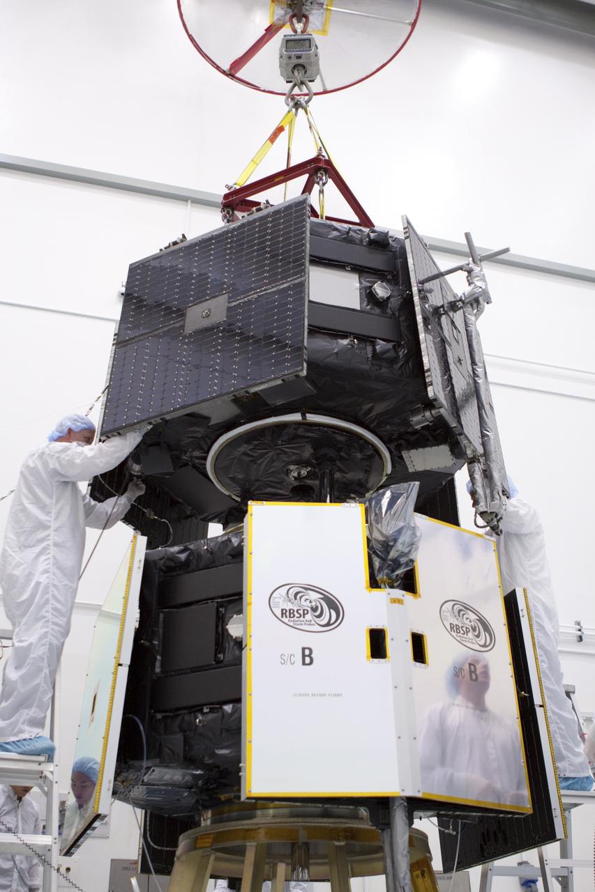 TITUSVILLE, Fla. - Inside the Astrotech payload processing facility in Titusville, Fla. near NASA’s Kennedy Space Center, technicians use a crane to position the Radiation Belt Storm Probes, or RBSP, spacecraft A for stacking atop RBSP B.      NASA’s RBSP mission will help us understand the sun’s influence on Earth and near-Earth space by studying the Earth’s radiation belts on various scales of space and time. RBSP will begin its mission of exploration of Earth’s Van Allen radiation belts and the extremes of space weather after its liftoff aboard a United Launch Alliance Atlas V from Space Launch Complex 41 at Cape Canaveral Air Force Station, Fla. Liftoff is targeted for Aug. 23, 2012. For more information, visit http://www.nasa.gov/rbsp. Photo credit: NASA/Jim Grossmann