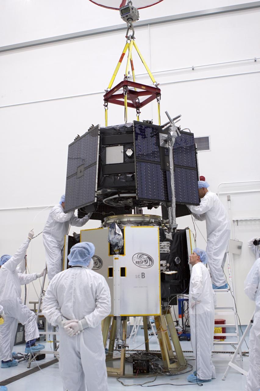 TITUSVILLE, Fla. - Inside the Astrotech payload processing facility in Titusville, Fla. near NASA’s Kennedy Space Center, technicians use a crane to position the Radiation Belt Storm Probes, or RBSP, spacecraft A atop RBSP B.      NASA’s RBSP mission will help us understand the sun’s influence on Earth and near-Earth space by studying the Earth’s radiation belts on various scales of space and time. RBSP will begin its mission of exploration of Earth’s Van Allen radiation belts and the extremes of space weather after its liftoff aboard a United Launch Alliance Atlas V from Space Launch Complex 41 at Cape Canaveral Air Force Station, Fla. Liftoff is targeted for Aug. 23, 2012. For more information, visit http://www.nasa.gov/rbsp. Photo credit: NASA/Jim Grossmann