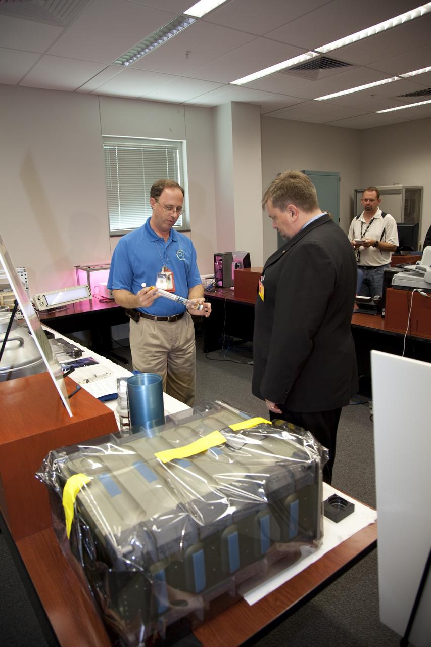 CAPE CANAVERAL, Fla. – David Reed, left, explains an innovation developed at NASA's Kennedy Space Center to Mason Peck, center, NASA's chief Technologist, during Pecks' tour of the Space Life Sciences Laboratory at Kennedy. Peck toured the lab facility during a visit to the space center. Photo credit: NASA/Frankie Martin