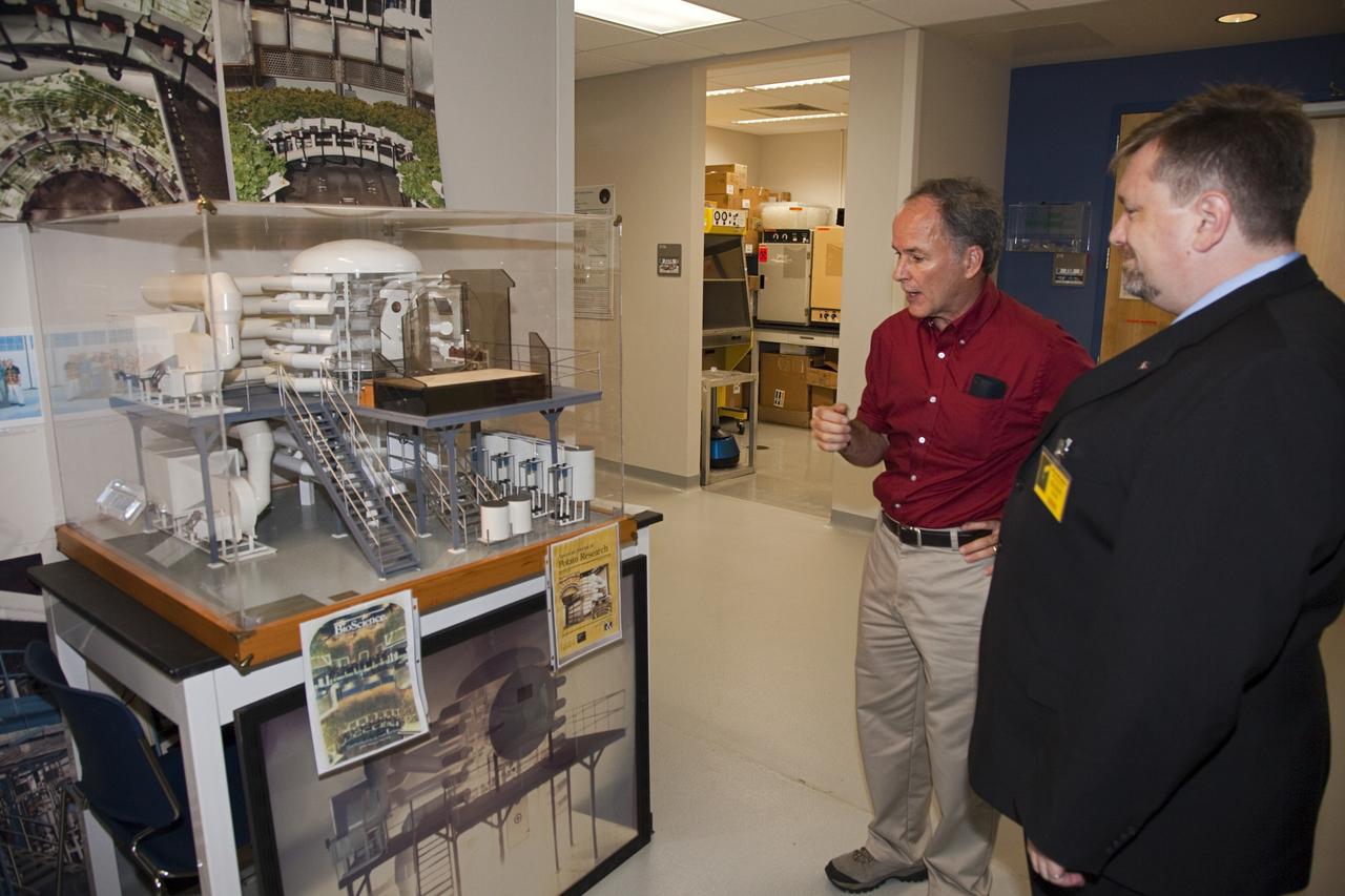 CAPE CANAVERAl, Fla. - Dr. Ray Wheeler, left, explains plant growth experimentation facilities to Dr. Mason Peck, NASA's chief Technologist, during a tour of the Space Life Sciences Laboratory at Kennedy. Peck toured the lab facility during a visit to the space center. Photo credit: NASA/Frankie Martin