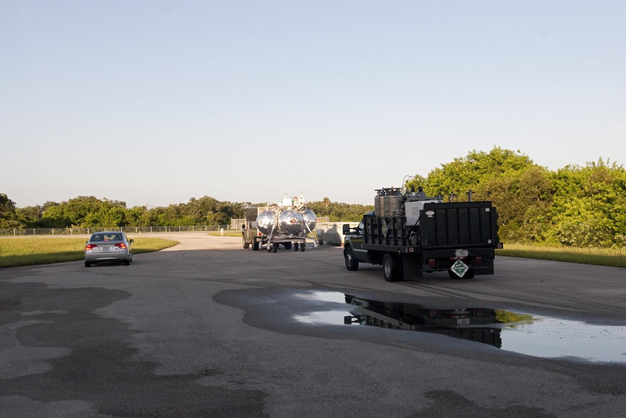 CAPE CANAVERAL, Fla. - NASA's Morpheus lander, a vertical test bed vehicle, is being transported out from its checkout building for a short trip to a launch position at the Shuttle Landing Facility, or SLF, at the Kennedy Space Center in Florida. Morpheus is designed to demonstrate new green propellant propulsion systems and autonomous landing and an Autonomous Landing and Hazard Avoidance Technology, or ALHAT, system. Checkout of the prototype lander has been ongoing at NASA’s Johnson Space Center in Houston in preparation for its first free flight. The SLF site will provide the lander with the kind of field necessary for realistic testing. Project Morpheus is one of 20 small projects comprising the Advanced Exploration Systems, or AES, program in NASA’s Human Exploration and Operations Mission Directorate. AES projects pioneer new approaches for rapidly developing prototype systems, demonstrating key capabilities and validating operational concepts for future human missions beyond Earth orbit. For more information on Project Morpheus, visit http://www.nasa.gov/centers/johnson/exploration/morpheus/index.html Photo credit: NASA/Dimitri Gerondidakis