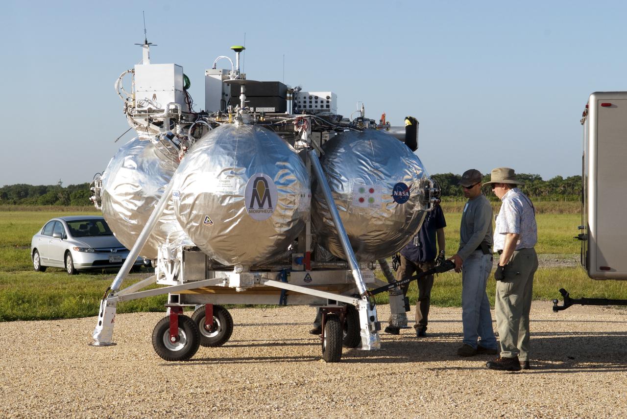 CAPE CANAVERAL, Fla. - NASA's Morpheus lander, a vertical test bed vehicle, is being set up at its launch position along the runway at the Shuttle Landing Facility, or SLF, at the Kennedy Space Center in Florida. Morpheus is designed to demonstrate new green propellant propulsion systems and autonomous landing and an Autonomous Landing and Hazard Avoidance Technology, or ALHAT, system. Checkout of the prototype lander has been ongoing at NASA’s Johnson Space Center in Houston in preparation for its first free flight. The SLF site will provide the lander with the kind of field necessary for realistic testing. Project Morpheus is one of 20 small projects comprising the Advanced Exploration Systems, or AES, program in NASA’s Human Exploration and Operations Mission Directorate. AES projects pioneer new approaches for rapidly developing prototype systems, demonstrating key capabilities and validating operational concepts for future human missions beyond Earth orbit. For more information on Project Morpheus, visit http://www.nasa.gov/centers/johnson/exploration/morpheus/index.html Photo credit: NASA/Dimitri Gerondidakis