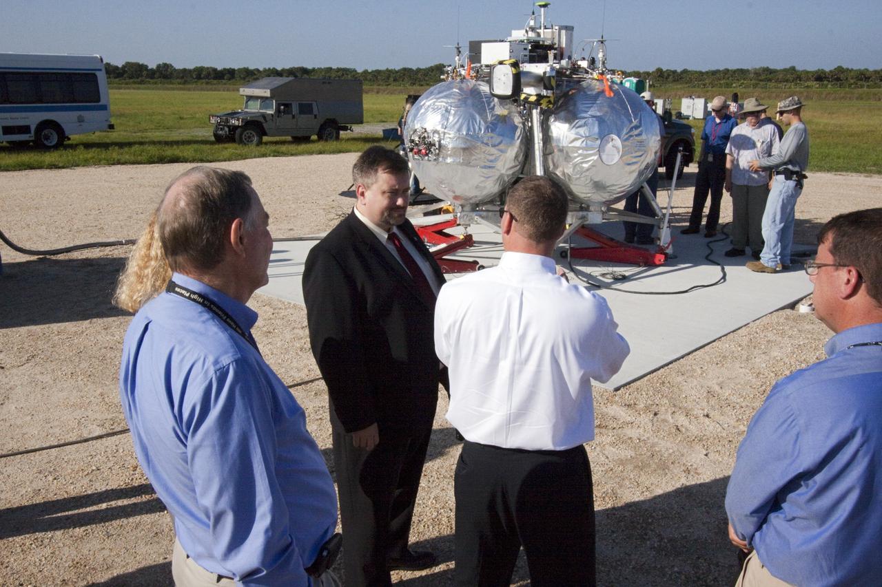 CAPE CANAVERAL, Fla. – Dr. Mason Peck, NASA's chief technologist, talks with managers of the Morpheus lander that will soon begin flight and landing tests at the Shuttle Landing Facility at NASA's Kennedy Space Center in Florida. Photo credit: NASA/Jim Grossman