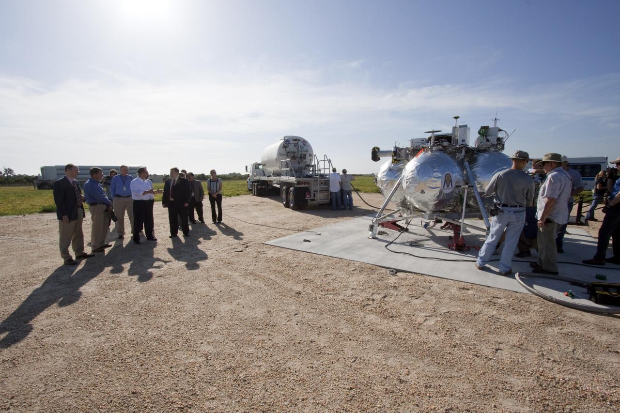 CAPE CANAVERAL, Fla. – Dr. Mason Peck, NASA's chief technologist, talks with managers of the Morpheus lander that will soon begin flight and landing tests at the Shuttle Landing Facility at NASA's Kennedy Space Center in Florida. Photo credit: NASA/Jim Grossman