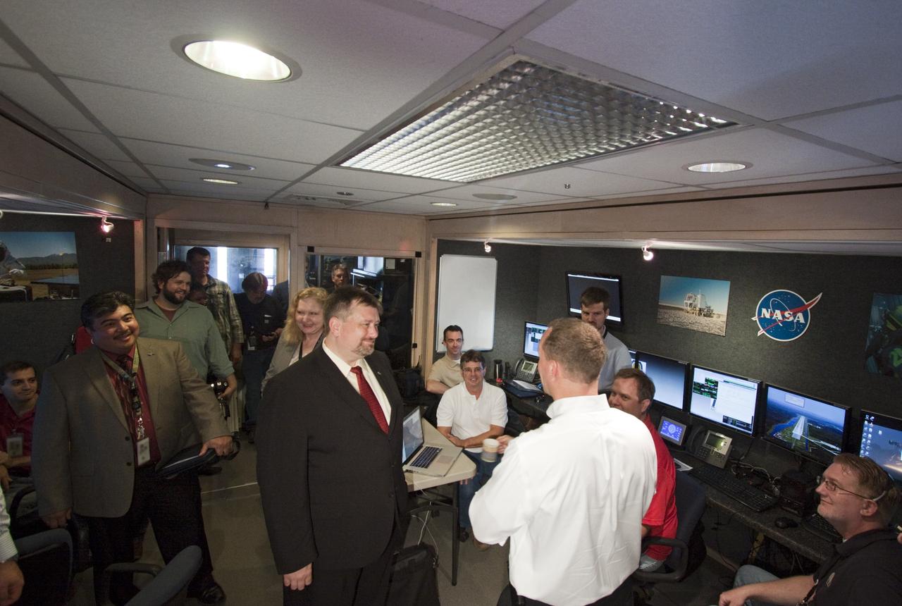 CAPE CANAVERAL, Fla. – Dr. Mason Peck, center, NASA's chief technologist, talks with managers of the Morpheus lander that will soon begin flight and landing tests at the Shuttle Landing Facility at NASA's Kennedy Space Center in Florida. Photo credit: NASA/Jim Grossmann