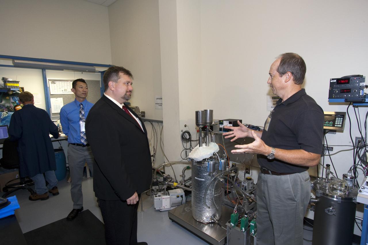 CAPE CANAVERAL, Fla. – James Fesmire, right, talks to Dr. Mason Peck, NASA's chief technologist, inside the Cryogenics lab at NASA's Kennedy Space Center in Florida as Johnny Nguyen, second from left, looks on. Photo credit: NASA/Jim Grossman