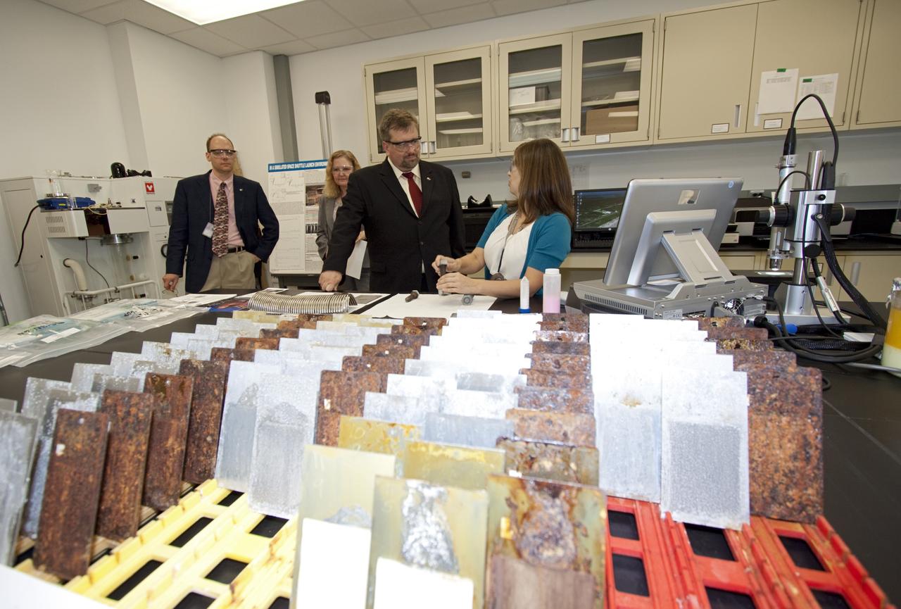 CAPE CANAVERAL, Fla. – Eliza Montgomery, right, talks to Dr. Mason Peck, NASA's chief technologist, inside the Corrosion lab at NASA's Kennedy Space Center in Florida as David Steitz, left, and Karen Thompson, Kennedy's chief technologist, look on. Photo credit: NASA/Jim Grossmann
