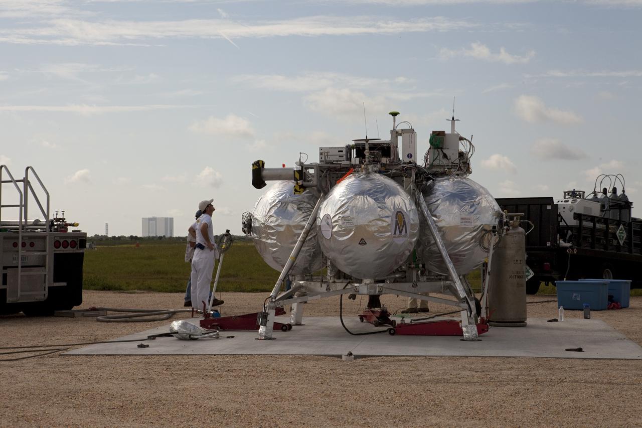 CAPE CANAVERAL, Fla. - At the north end of the Shuttle Landing Facility, or SLF, at the Kennedy Space Center in Florida, technicians check out NASA's Morpheus lander, a vertical test bed vehicle. A rock and crater-filled planetary scape, has been built so engineers can test the Autonomous Landing and Hazard Avoidance Technology, or ALHAT, system on the Project Morpheus lander. Checkout of the prototype lander has been ongoing at NASA’s Johnson Space Center in Houston in preparation for its first free flight. The SLF site will provide the lander with the kind of field necessary for realistic testing. Project Morpheus is one of 20 small projects comprising the Advanced Exploration Systems, or AES, program in NASA’s Human Exploration and Operations Mission Directorate. AES projects pioneer new approaches for rapidly developing prototype systems, demonstrating key capabilities and validating operational concepts for future human missions beyond Earth orbit. For more information on Project Morpheus, visit http://www.nasa.gov/centers/johnson/exploration/morpheus/index.html Photo credit: NASA/Kim Shiflett