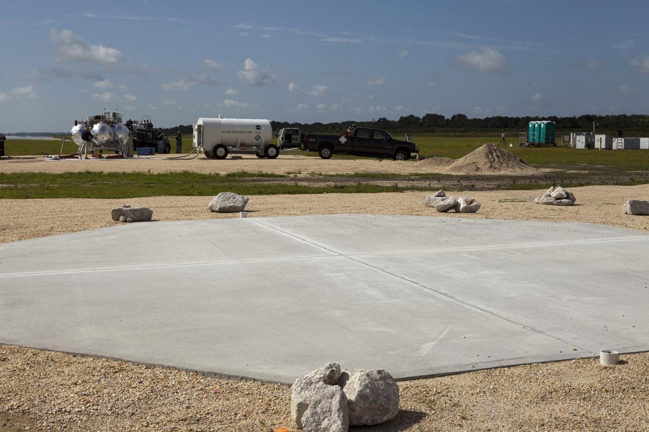 CAPE CANAVERAL, Fla. - At the north end of the Shuttle Landing Facility, or SLF, at the Kennedy Space Center in Florida, NASA's Morpheus lander, a vertical test bed vehicle, is being prepared for further assessment. A rock and crater-filled planetary scape, seen in the foreground, has been built so engineers can test the Autonomous Landing and Hazard Avoidance Technology, or ALHAT, system on the Project Morpheus lander. Checkout of the prototype lander has been ongoing at NASA’s Johnson Space Center in Houston in preparation for its first free flight. The SLF site will provide the lander with the kind of field necessary for realistic testing. Project Morpheus is one of 20 small projects comprising the Advanced Exploration Systems, or AES, program in NASA’s Human Exploration and Operations Mission Directorate. AES projects pioneer new approaches for rapidly developing prototype systems, demonstrating key capabilities and validating operational concepts for future human missions beyond Earth orbit. For more information on Project Morpheus, visit http://www.nasa.gov/centers/johnson/exploration/morpheus/index.html Photo credit: NASA/Kim Shiflett