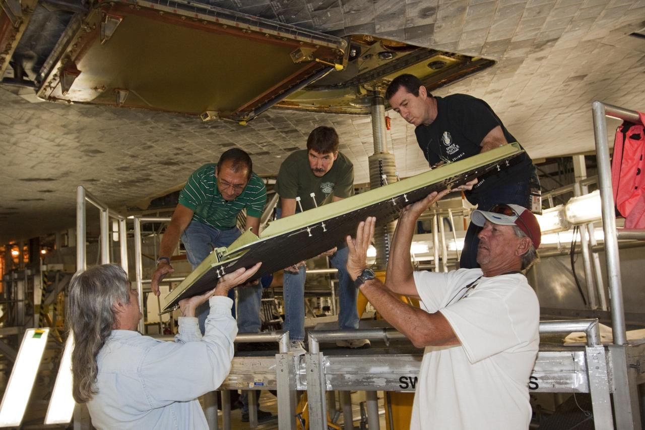 CAPE CANAVERAL, Fla. – Inside Orbiter Processing Facility-2 at NASA’s Kennedy Space Center in Florida, United Space Alliance technicians prepare to install a ferry flight door on space shuttle Endeavour.     The work is part of Transition and Retirement of the remaining space shuttles, Endeavour and Atlantis. Endeavour is being prepared for public display at the California Science Center in Los Angeles. Its ferry flight to California is targeted for mid-September. Endeavour was the last space shuttle added to NASA’s orbiter fleet. Over the course of its 19-year career, Endeavour spent 299 days in space during 25 missions. For more information, visit http://www.nasa.gov/shuttle.  Photo credit: NASA/Jim Grossmann