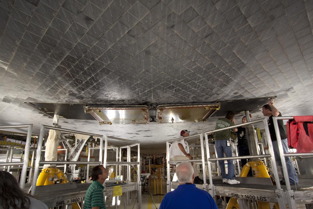 CAPE CANAVERAL, Fla. – Inside Orbiter Processing Facility-2 at NASA’s Kennedy Space Center in Florida, United Space Alliance technicians install the ferry flight doors on space shuttle Endeavour.     The work is part of Transition and Retirement of the remaining space shuttles, Endeavour and Atlantis. Endeavour is being prepared for public display at the California Science Center in Los Angeles. Its ferry flight to California is targeted for mid-September. Endeavour was the last space shuttle added to NASA’s orbiter fleet. Over the course of its 19-year career, Endeavour spent 299 days in space during 25 missions. For more information, visit http://www.nasa.gov/shuttle.  Photo credit: NASA/Jim Grossmann