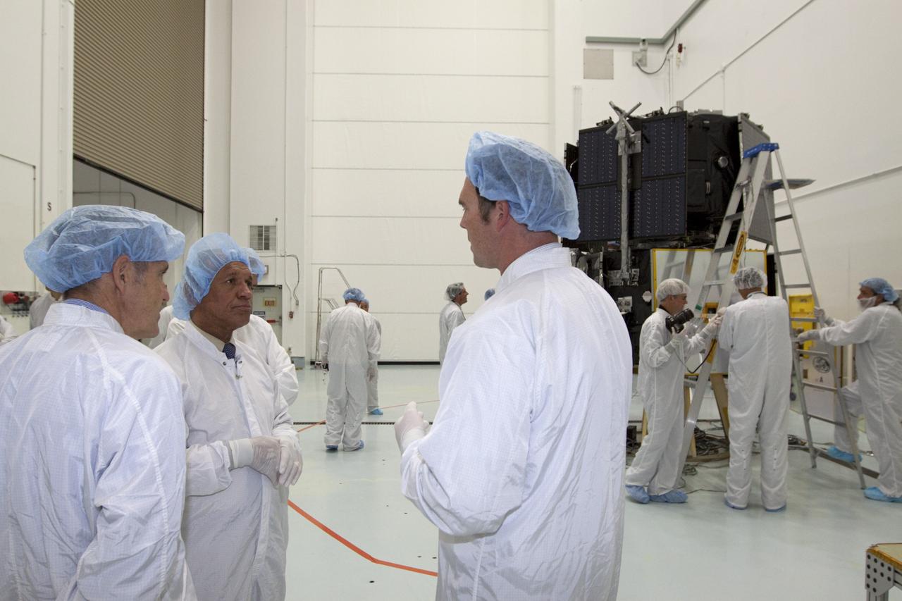 CAPE CANAVERAL, Fla. - Inside the Astrotech payload processing facility near NASA’s Kennedy Space Center in Florida, from left, Kennedy Space Center Director Bob Cabana and NASA Administrator Charlie Bolden listen as a technician talks about the Radiation Belt Storm Probes, or RBSP, spacecraft. NASA’s RBSP mission will help us understand the sun’s influence on Earth and near-Earth space by studying the Earth’s radiation belts on various scales of space and time. As the spacecraft orbits Earth, the four solar panels will continuously face the sun to provide constant power to its instruments. The boom will provide data of the electric fields that energize radiation particles and modify the structure of the inner magnetosphere. RBSP will begin its mission of exploration of Earth’s Van Allen radiation belts and the extremes of space weather after its launch aboard a United Launch Alliance Atlas V rocket. Launch is targeted for Aug. 23. For more information, visit http://www.nasa.gov/rbsp. Photo credit: NASA/Kim Shiflett