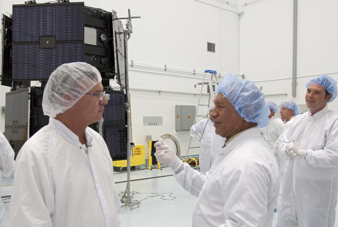 CAPE CANAVERAL, Fla. - Inside the Astrotech payload processing facility near NASA’s Kennedy Space Center in Florida, NASA Administrator Charlie Bolden, center, talks to technicians about the Radiation Belt Storm Probes, or RBSP, spacecraft. NASA’s RBSP mission will help us understand the sun’s influence on Earth and near-Earth space by studying the Earth’s radiation belts on various scales of space and time. As the spacecraft orbits Earth, the four solar panels will continuously face the sun to provide constant power to its instruments. The boom will provide data of the electric fields that energize radiation particles and modify the structure of the inner magnetosphere. RBSP will begin its mission of exploration of Earth’s Van Allen radiation belts and the extremes of space weather after its launch aboard a United Launch Alliance Atlas V rocket. Launch is targeted for Aug. 23. For more information, visit http://www.nasa.gov/rbsp. Photo credit: NASA/Kim Shiflett