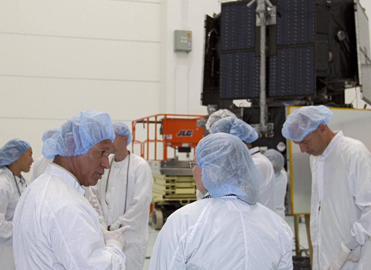 CAPE CANAVERAL, Fla. - Inside the Astrotech payload processing facility near NASA’s Kennedy Space Center in Florida, NASA Administrator Charlie Bolden, at left, talks to technicians about the Radiation Belt Storm Probes, or RBSP, spacecraft. NASA’s RBSP mission will help us understand the sun’s influence on Earth and near-Earth space by studying the Earth’s radiation belts on various scales of space and time. As the spacecraft orbits Earth, the four solar panels will continuously face the sun to provide constant power to its instruments. The boom will provide data of the electric fields that energize radiation particles and modify the structure of the inner magnetosphere. RBSP will begin its mission of exploration of Earth’s Van Allen radiation belts and the extremes of space weather after its launch aboard a United Launch Alliance Atlas V rocket. Launch is targeted for Aug. 23. For more information, visit http://www.nasa.gov/rbsp. Photo credit: NASA/Kim Shiflett
