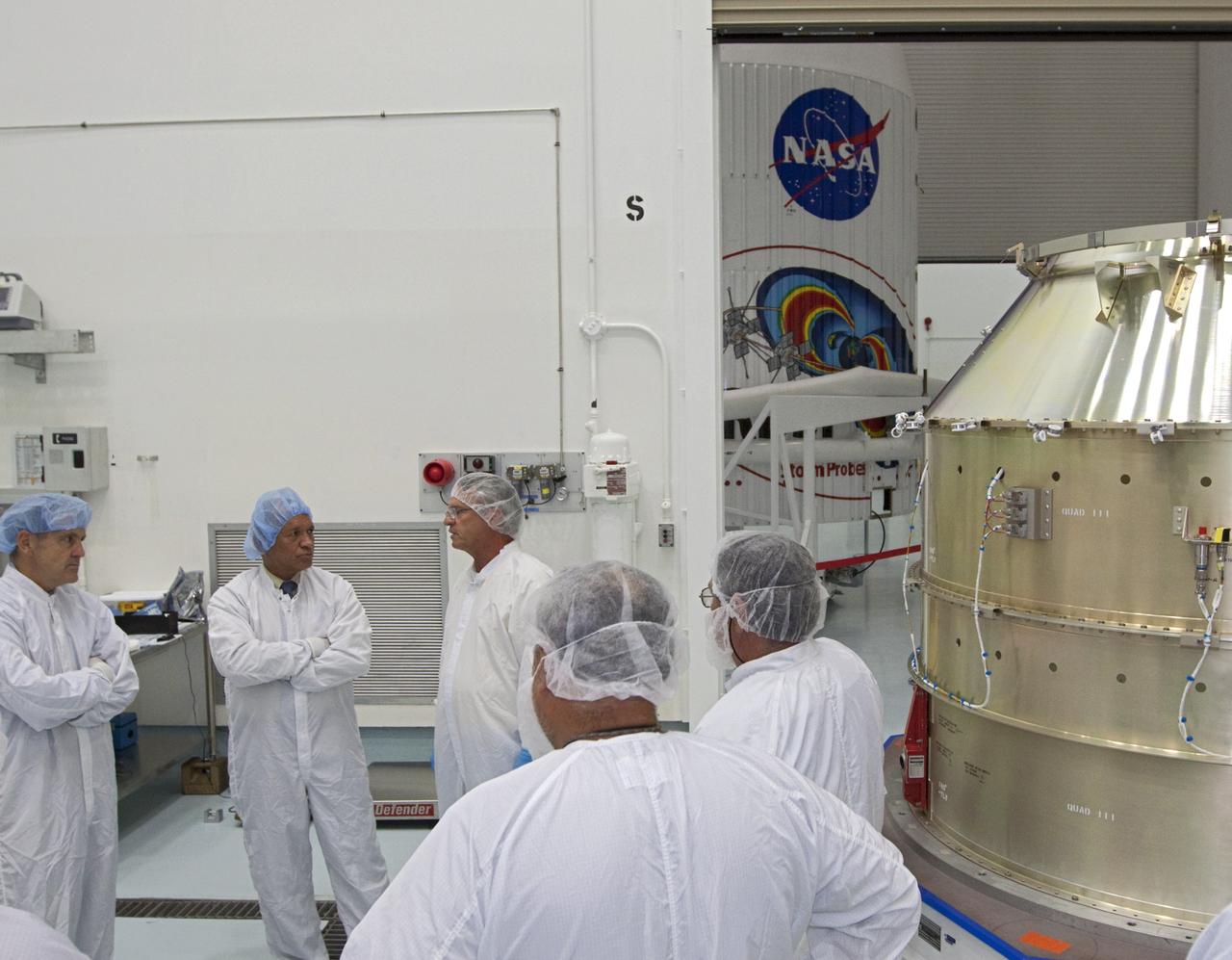 CAPE CANAVERAL, Fla. - Inside the Astrotech payload processing facility near NASA’s Kennedy Space Center in Florida, Kennedy Space Center Director Bob Cabana, left, and NASA Administrator Charlie Bolden talk to technicians about the Radiation Belt Storm Probes, or RBSP, spacecraft. NASA’s RBSP mission will help us understand the sun’s influence on Earth and near-Earth space by studying the Earth’s radiation belts on various scales of space and time. As the spacecraft orbits Earth, the four solar panels will continuously face the sun to provide constant power to its instruments. The boom will provide data of the electric fields that energize radiation particles and modify the structure of the inner magnetosphere. RBSP will begin its mission of exploration of Earth’s Van Allen radiation belts and the extremes of space weather after its launch aboard a United Launch Alliance Atlas V rocket. Launch is targeted for Aug. 23. For more information, visit http://www.nasa.gov/rbsp. Photo credit: NASA/Kim Shiflett