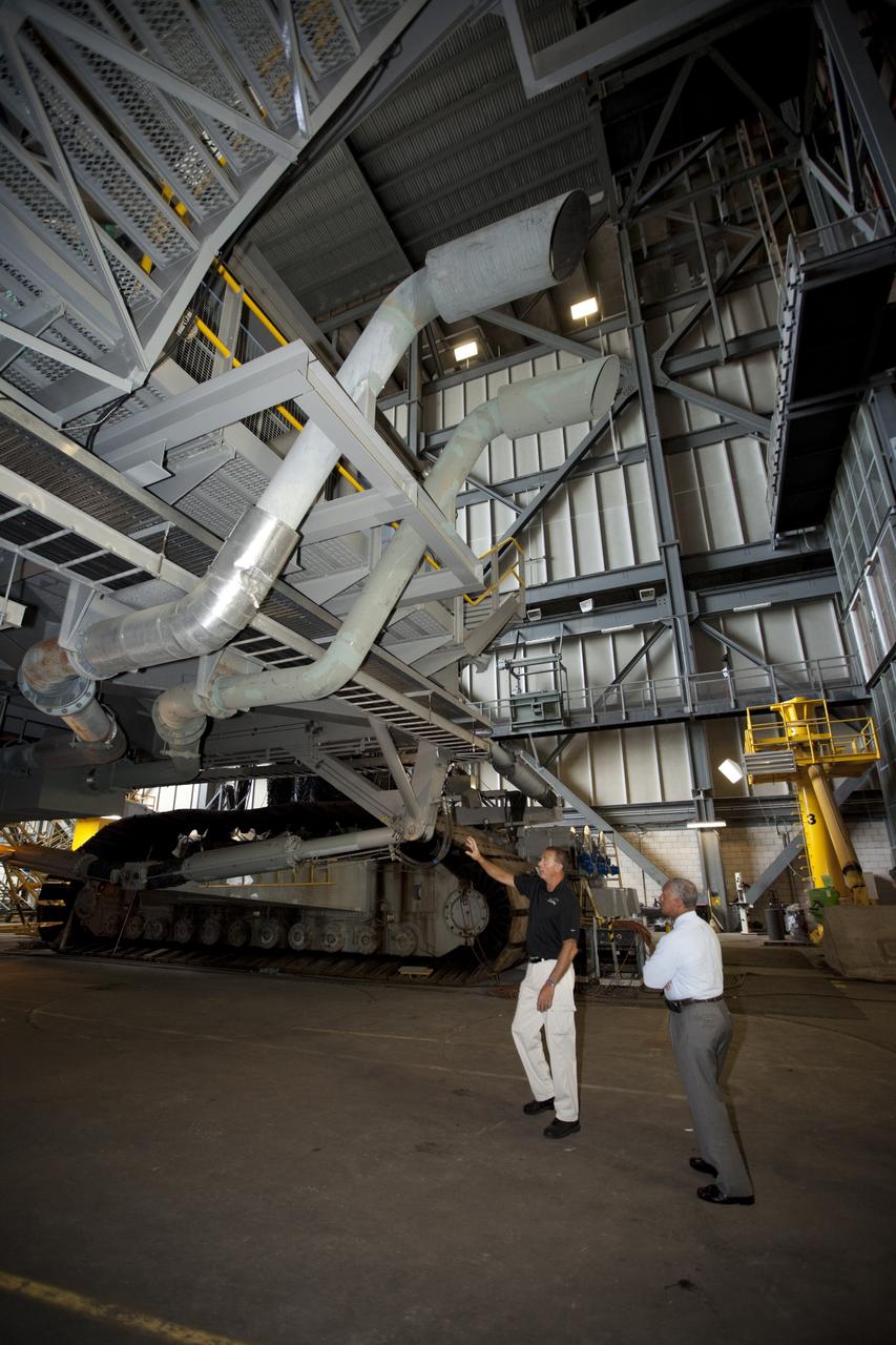 Cape Canaveral, Fla. -- NASA Administrator Charlie Bolden sees firsthand how Kennedy Space Center is transitioning to a spaceport of the future as Kennedy's Mike Parrish explains the upcoming use of the crawler-transporter, which has carried space vehicles to the launch pad since the Apollo Program.    NASA is working with U.S. industry partners to develop commercial spaceflight capabilities to low Earth orbit as the agency also is developing the Orion Multi-Purpose Crew Vehicle MPCV and the Space Launch System SLS, a crew capsule and heavy-lift rocket to provide an entirely new capability for human exploration. Designed to be flexible for launching spacecraft for crew and cargo missions, SLS and Orion MPCV will expand human presence beyond low Earth orbit and enable new missions of exploration across the solar system.    Photo credit: NASA/Kim Shiflett