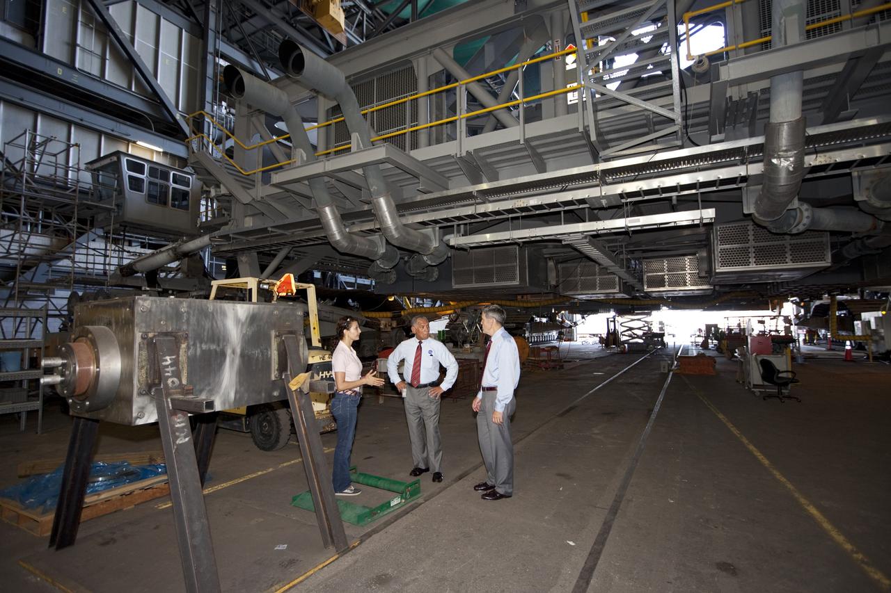 CAPE CANAVERAL, Fla. – NASA Administrator Charlie Bolden, accompanied by Center Director Bob Cabana, sees firsthand how NASA's Kennedy Space Center is transiting to a spaceport of the future as Kennedy's Mary Hanna explains the upcoming uses for the crawler-transporter that has carried space vehicles to the launch pad since the Apollo Program. NASA is working with U.S. industry partners to develop commercial spaceflight capabilities to low Earth orbit as the agency also is developing the Orion Multi-Purpose Crew Vehicle MPCV and the Space Launch System SLS, a crew capsule and heavy-lift rocket to provide an entirely new capability for human exploration. Designed to be flexible for launching spacecraft for crew and cargo missions, SLS and Orion MPCV will expand human presence beyond low Earth orbit and enable new missions of exploration across the solar system. Photo credit: NASA/Kim Shiflett