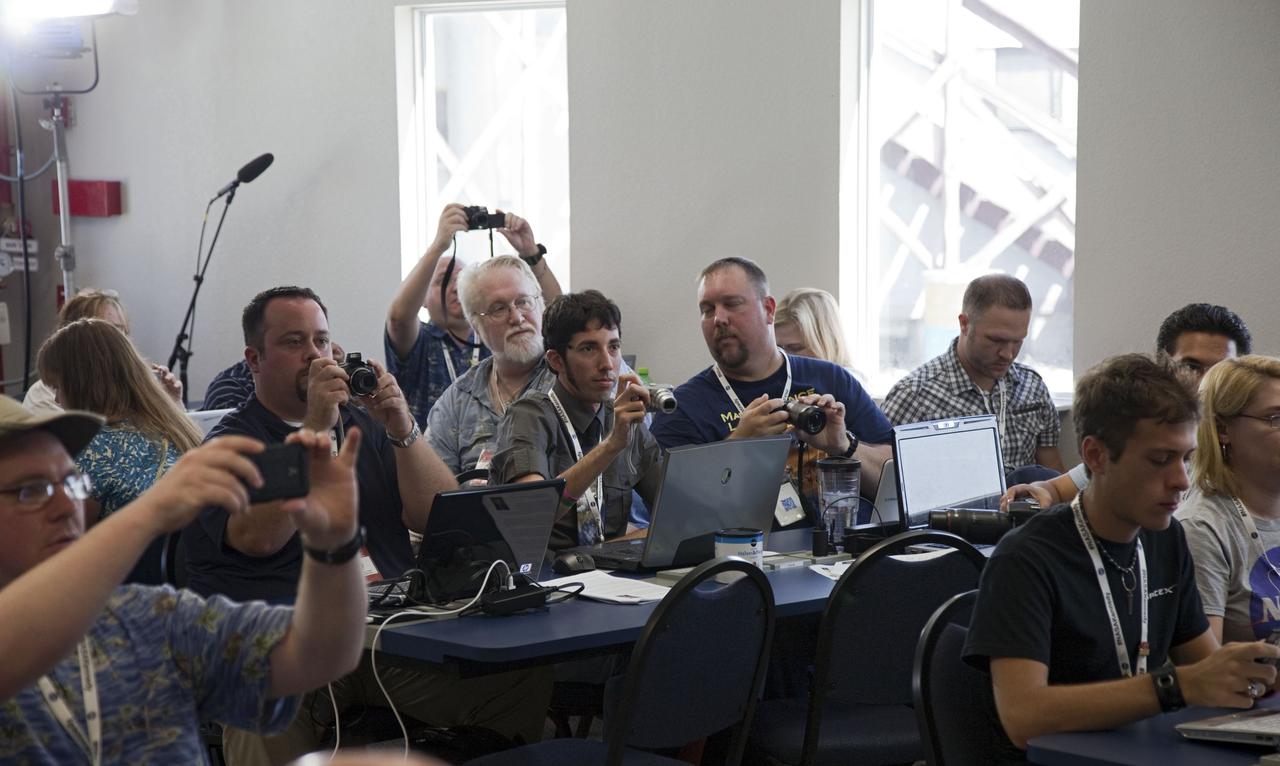 CAPE CANAVERAL, Fla. -- Several of the 45 of NASA social media followers photograph a speaker during two days of presentations on the Kennedy Space Center's past, present and future.      The social media participants gathered at the Florida spaceport on Aug. 2 and 3, 2012 to hear from key former and current leaders who related stories of the space agency's efforts to explore the unknown. It was the first social media event totally run by Kennedy. Photo credit: NASA/ Gianni Woods