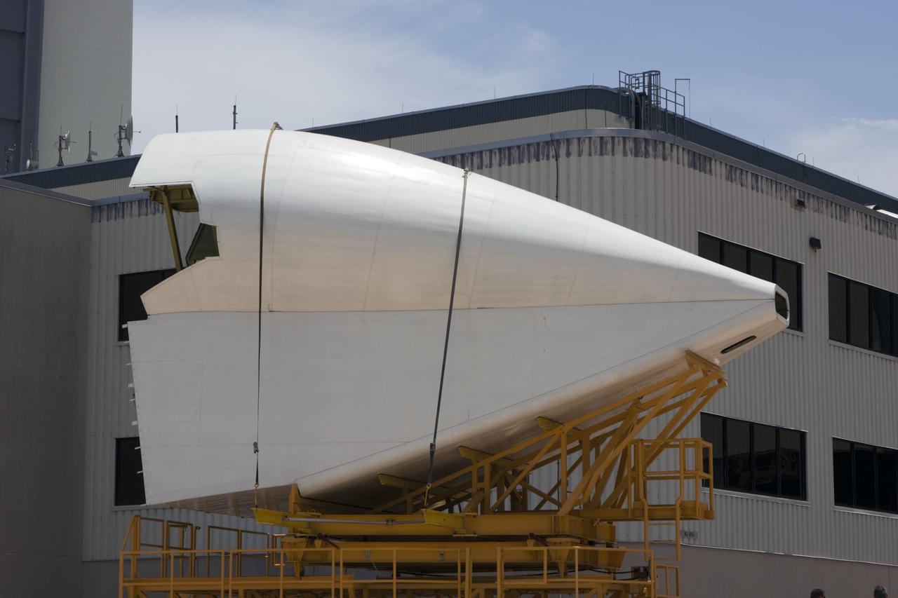 CAPE CANAVERAL, Fla. -- The tail cone that will cover space shuttle Endeavour’s replica shuttle main engines arrives at Orbiter Processing Facility-2, or OPF-2, from the Vehicle Assembly Building at NASA’s Kennedy Space Center in Florida. Inside OPF-2, the tail cone will be installed on Endeavour.    The work is part of Transition and Retirement of the remaining space shuttles, Endeavour and Atlantis. Endeavour is being prepared for public display at the California Science Center in Los Angeles. Its ferry flight to California is targeted for mid-September. Endeavour was the last space shuttle added to NASA’s orbiter fleet. Over the course of its 19-year career, Endeavour spent 299 days in space during 25 missions. For more information, visit http://www.nasa.gov/shuttle.  Photo credit: NASA/Jim Grossmann