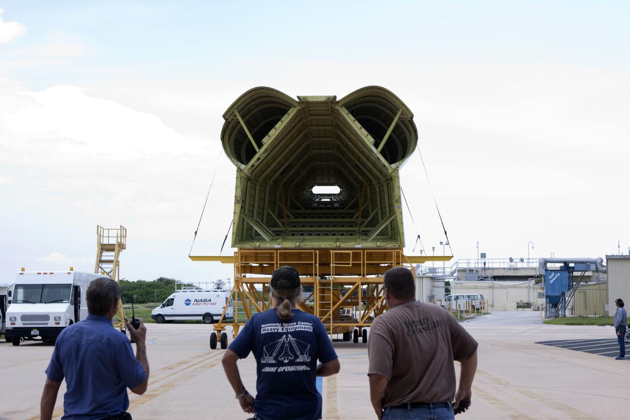 CAPE CANAVERAL, Fla. -- United Space Alliance technicians monitor the progress as the tail cone that will cover space shuttle Endeavour’s replica shuttle main engines arrives at Orbiter Processing Facility-2, or OPF-2, from the Vehicle Assembly Building at NASA’s Kennedy Space Center in Florida. Inside OPF-2, the tail cone will be installed on Endeavour.    The work is part of Transition and Retirement of the remaining space shuttles, Endeavour and Atlantis. Endeavour is being prepared for public display at the California Science Center in Los Angeles. Its ferry flight to California is targeted for mid-September. Endeavour was the last space shuttle added to NASA’s orbiter fleet. Over the course of its 19-year career, Endeavour spent 299 days in space during 25 missions. For more information, visit http://www.nasa.gov/shuttle.  Photo credit: NASA/Jim Grossmann