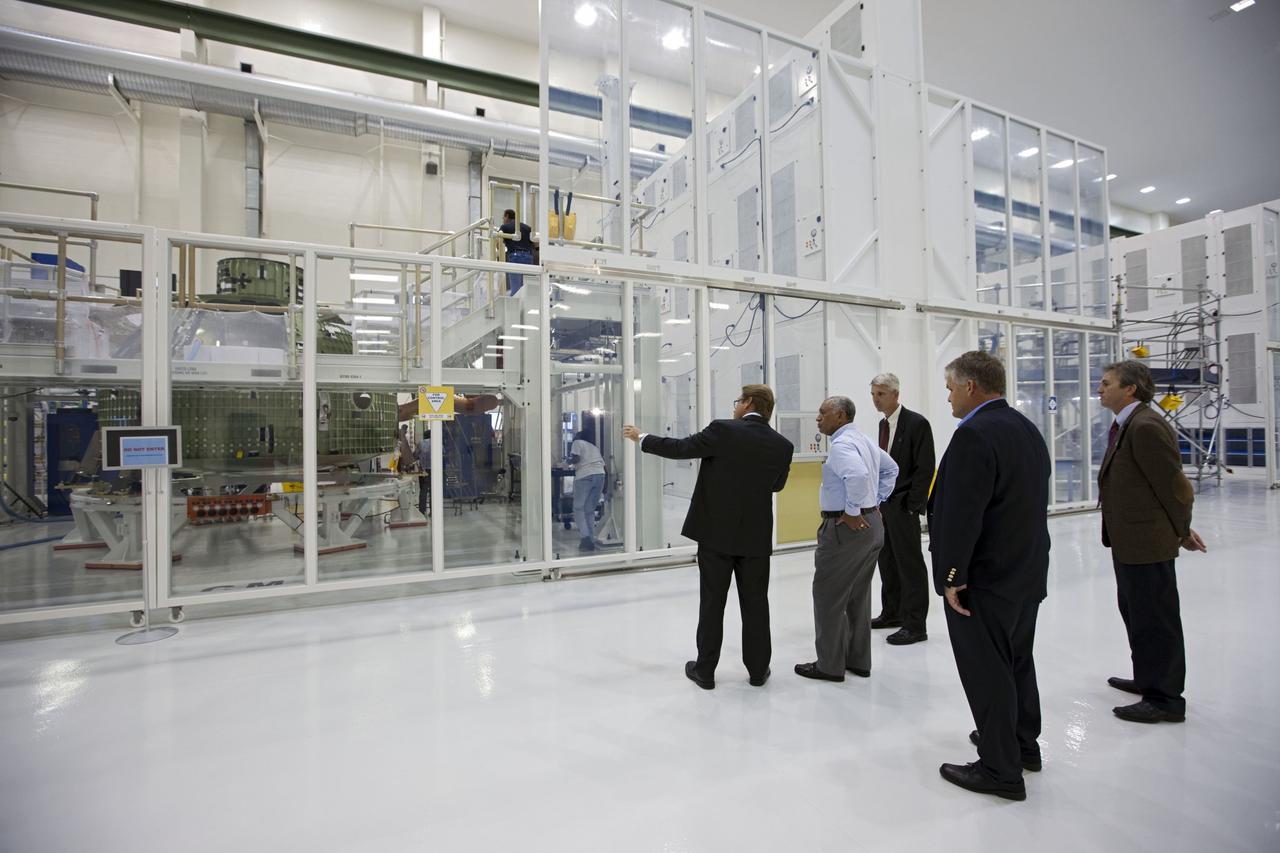 CAPE CANAVERAL, Fla. – Charles Bolden, NASA administrator, center, is shown the Orion capsule that will make an uncrewed flight test in 2014. The spacecraft is in the high bay at the Operations and Checkout Building at NASA's Kennedy Space Center in Florida. Photo credit: NASA/Kim Shifflett