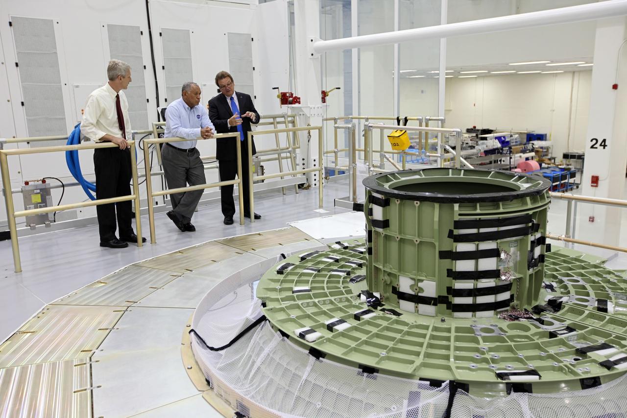 CAPE CANAVERAL, Fla. – Lockheed Martin's Jules Schneider, right, shows the upper portion of the Orion capsule to Charles Bolden, NASA administrator, center, as NASA's Scott Wilson looks on. The Orion capsule will make an uncrewed flight test in 2014. The spacecraft is in the high bay at the Operations and Checkout Building at NASA's Kennedy Space Center in Florida. Photo credit: NASA/Kim Shifflett