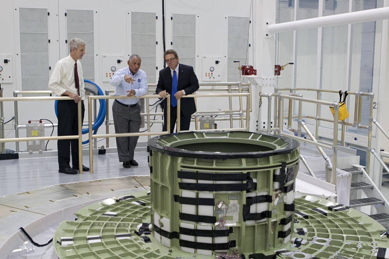 CAPE CANAVERAL, Fla. – Lockheed Martin's Jules Schneider, right, shows the upper portion of the Orion capsule to Charles Bolden, NASA administrator, center, as NASA's Scott Wilson looks on. The Orion capsule will make an uncrewed flight test in 2014. The spacecraft is in the high bay at the Operations and Checkout Building at NASA's Kennedy Space Center in Florida. Photo credit: NASA/Kim Shifflett