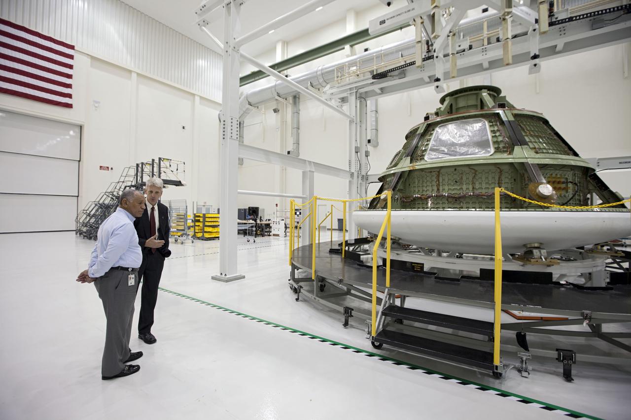 CAPE CANAVERAL, Fla. – NASA's Scott Wilson, right, shows the Orion ground test article to Charles Bolden, NASA administrator, left. The test article is used to perfect processing and equipment steps before they are performed on the flight version of the capsule. The spacecraft is in the high bay at the Operations and Checkout Building at NASA's Kennedy Space Center in Florida. Photo credit: NASA/Kim Shifflett