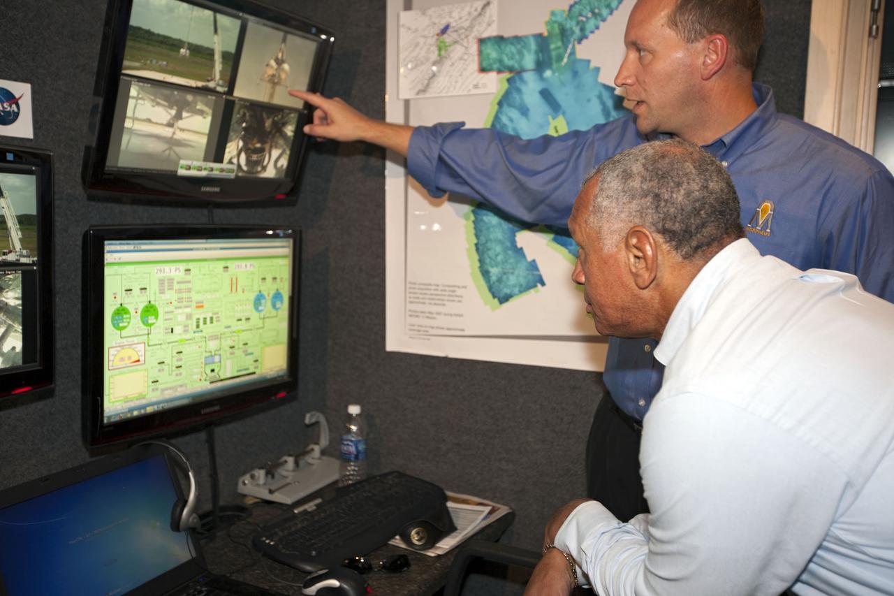 CAPE CANAVERAL, Fla. – At NASA’s Kennedy Space Center in Florida, NASA Administrator Charles Bolden joins Morpheus project manager Dr. Jon Olansen, pointing at monitor, in the control room at the Shuttle Landing Facility for the first tethered flight of the Morpheus lander.    After undergoing testing at Johnson Space Center in Houston for nearly a year, Morpheus arrived at Kennedy on July 27 to begin about three months of tests. A field, replete with boulders, rocks, slopes, craters and hazards to avoid, was created at the north end of Kennedy's runway to provide a realistic landscape for test flights of the lander. Morpheus utilizes autonomous landing and hazard avoidance technology, or ALHAT, to navigate to a safe landing site during its descent. Project Morpheus is one of 20 small projects comprising the Advanced Exploration Systems, or AES, program in NASA's Human Exploration and Operations Mission Directorate. AES projects pioneer new approaches for rapidly developing prototype systems, demonstrating key capabilities and validating operational concepts for future human missions beyond Earth orbit.  For more information on Project Morpheus, visit http://www.nasa.gov/centers/johnson/exploration/morpheus/index.html.  Photo credit: NASA/Kim Shiflett