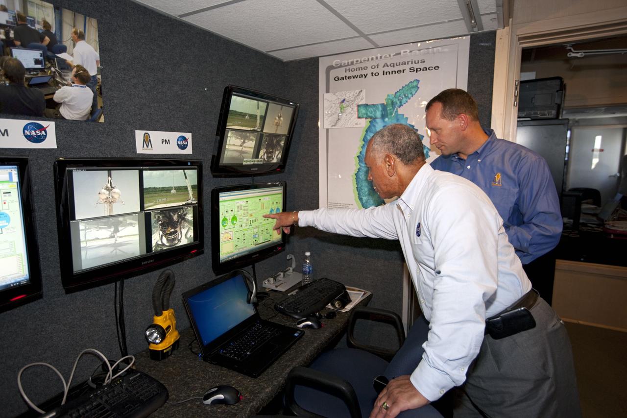CAPE CANAVERAL, Fla. – At NASA’s Kennedy Space Center in Florida, NASA Administrator Charles Bolden, left, joins Dr. Jon Olansen, Morpheus project manager, in the control room at the Shuttle Landing Facility for the first tethered flight of the Morpheus lander.    After undergoing testing at Johnson Space Center in Houston for nearly a year, Morpheus arrived at Kennedy on July 27 to begin about three months of tests. A field, replete with boulders, rocks, slopes, craters and hazards to avoid, was created at the north end of Kennedy's runway to provide a realistic landscape for test flights of the lander. Morpheus utilizes autonomous landing and hazard avoidance technology, or ALHAT, to navigate to a safe landing site during its descent. Project Morpheus is one of 20 small projects comprising the Advanced Exploration Systems, or AES, program in NASA's Human Exploration and Operations Mission Directorate. AES projects pioneer new approaches for rapidly developing prototype systems, demonstrating key capabilities and validating operational concepts for future human missions beyond Earth orbit.  For more information on Project Morpheus, visit http://www.nasa.gov/centers/johnson/exploration/morpheus/index.html.  Photo credit: NASA/Kim Shiflett