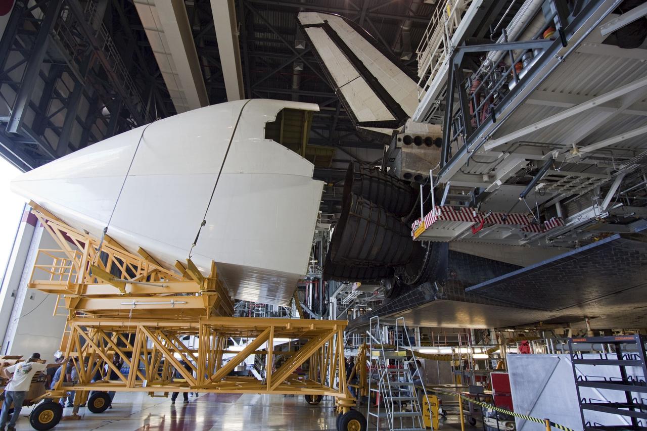 CAPE CANAVERAL, Fla. – In Orbiter Processing Facility Bay 2 at NASA’s Kennedy Space Center in Florida, United Space Alliance technicians move the tail cone into position for attachment to the space shuttle Endeavour. The tail cone covers the main engines in the aft providing aerodynamic stability during the cross-country ferry flight.      The work is part of Transition and Retirement of the remaining space shuttles, Endeavour and Atlantis. Endeavour is being prepared for public display at the California Science Center in Los Angeles. Its ferry flight to California is targeted for mid-September. Endeavour was the last space shuttle added to NASA’s orbiter fleet. Over the course of its 19-year career, Endeavour spent 299 days in space during 25 missions. For more information, visit http://www.nasa.gov/transition Photo credit: NASA/ Jim Grossmann