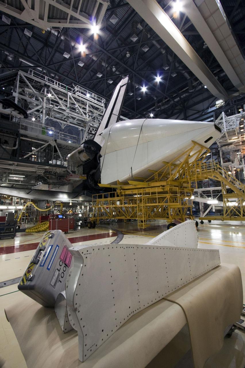 CAPE CANAVERAL, Fla. – In Orbiter Processing Facility Bay 2 at NASA’s Kennedy Space Center in Florida, the tail cone is moved into position for attachment to the space shuttle Endeavour. The tail cone covers the main engines in the aft providing aerodynamic stability during the cross-country ferry flight.      The work is part of Transition and Retirement of the remaining space shuttles, Endeavour and Atlantis. Endeavour is being prepared for public display at the California Science Center in Los Angeles. Its ferry flight to California is targeted for mid-September. Endeavour was the last space shuttle added to NASA’s orbiter fleet. Over the course of its 19-year career, Endeavour spent 299 days in space during 25 missions. For more information, visit http://www.nasa.gov/transition Photo credit: NASA/ Jim Grossmann