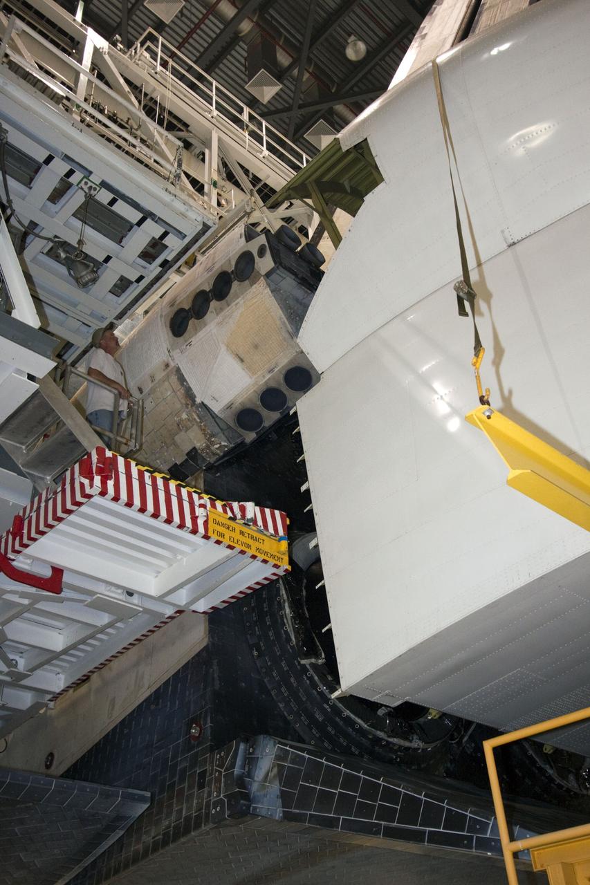 CAPE CANAVERAL, Fla. – In Orbiter Processing Facility Bay 2 at NASA’s Kennedy Space Center in Florida, the tail cone is moved into position surrounding the replica main engines on the space shuttle Endeavour. The tail cone covers the main engines in the aft providing aerodynamic stability during the cross-country ferry flight.      The work is part of Transition and Retirement of the remaining space shuttles, Endeavour and Atlantis. Endeavour is being prepared for public display at the California Science Center in Los Angeles. Its ferry flight to California is targeted for mid-September. Endeavour was the last space shuttle added to NASA’s orbiter fleet. Over the course of its 19-year career, Endeavour spent 299 days in space during 25 missions. For more information, visit http://www.nasa.gov/transition Photo credit: NASA/ Jim Grossmann
