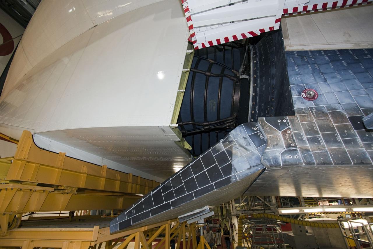 CAPE CANAVERAL, Fla. – In Orbiter Processing Facility Bay 2 at NASA’s Kennedy Space Center in Florida, the tail cone is moved into position surrounding the replica main engines on the space shuttle Endeavour. The tail cone covers the main engines in the aft providing aerodynamic stability during the cross-country ferry flight.      The work is part of Transition and Retirement of the remaining space shuttles, Endeavour and Atlantis. Endeavour is being prepared for public display at the California Science Center in Los Angeles. Its ferry flight to California is targeted for mid-September. Endeavour was the last space shuttle added to NASA’s orbiter fleet. Over the course of its 19-year career, Endeavour spent 299 days in space during 25 missions. For more information, visit http://www.nasa.gov/transition Photo credit: NASA/ Jim Grossmann