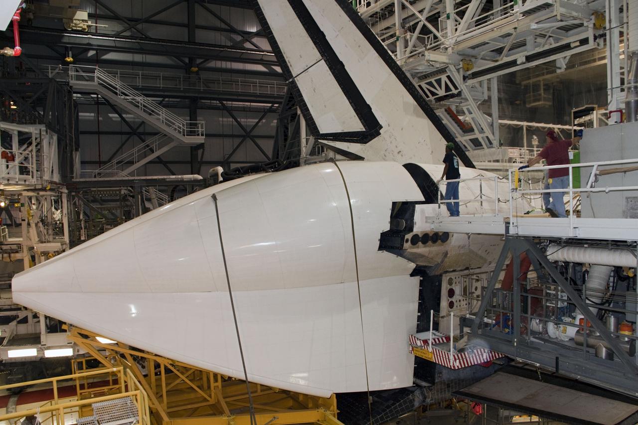 CAPE CANAVERAL, Fla. – In Orbiter Processing Facility Bay 2 at NASA’s Kennedy Space Center in Florida, the tail cone is moved into position surrounding the replica main engines on the space shuttle Endeavour. The tail cone covers the main engines in the aft providing aerodynamic stability during the cross-country ferry flight.      The work is part of Transition and Retirement of the remaining space shuttles, Endeavour and Atlantis. Endeavour is being prepared for public display at the California Science Center in Los Angeles. Its ferry flight to California is targeted for mid-September. Endeavour was the last space shuttle added to NASA’s orbiter fleet. Over the course of its 19-year career, Endeavour spent 299 days in space during 25 missions. For more information, visit http://www.nasa.gov/transition Photo credit: NASA/ Jim Grossmann