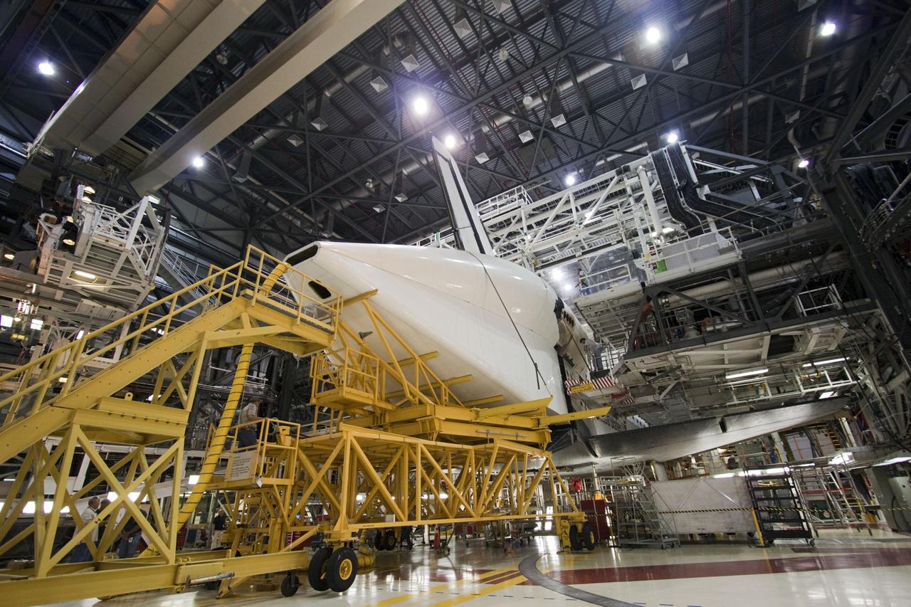 CAPE CANAVERAL, Fla. – In Orbiter Processing Facility Bay 2 at NASA’s Kennedy Space Center in Florida, the tail cone is moved into position surrounding the replica main engines on the space shuttle Endeavour. The tail cone covers the main engines in the aft providing aerodynamic stability during the cross-country ferry flight.      The work is part of Transition and Retirement of the remaining space shuttles, Endeavour and Atlantis. Endeavour is being prepared for public display at the California Science Center in Los Angeles. Its ferry flight to California is targeted for mid-September. Endeavour was the last space shuttle added to NASA’s orbiter fleet. Over the course of its 19-year career, Endeavour spent 299 days in space during 25 missions. For more information, visit http://www.nasa.gov/transition Photo credit: NASA/ Jim Grossmann