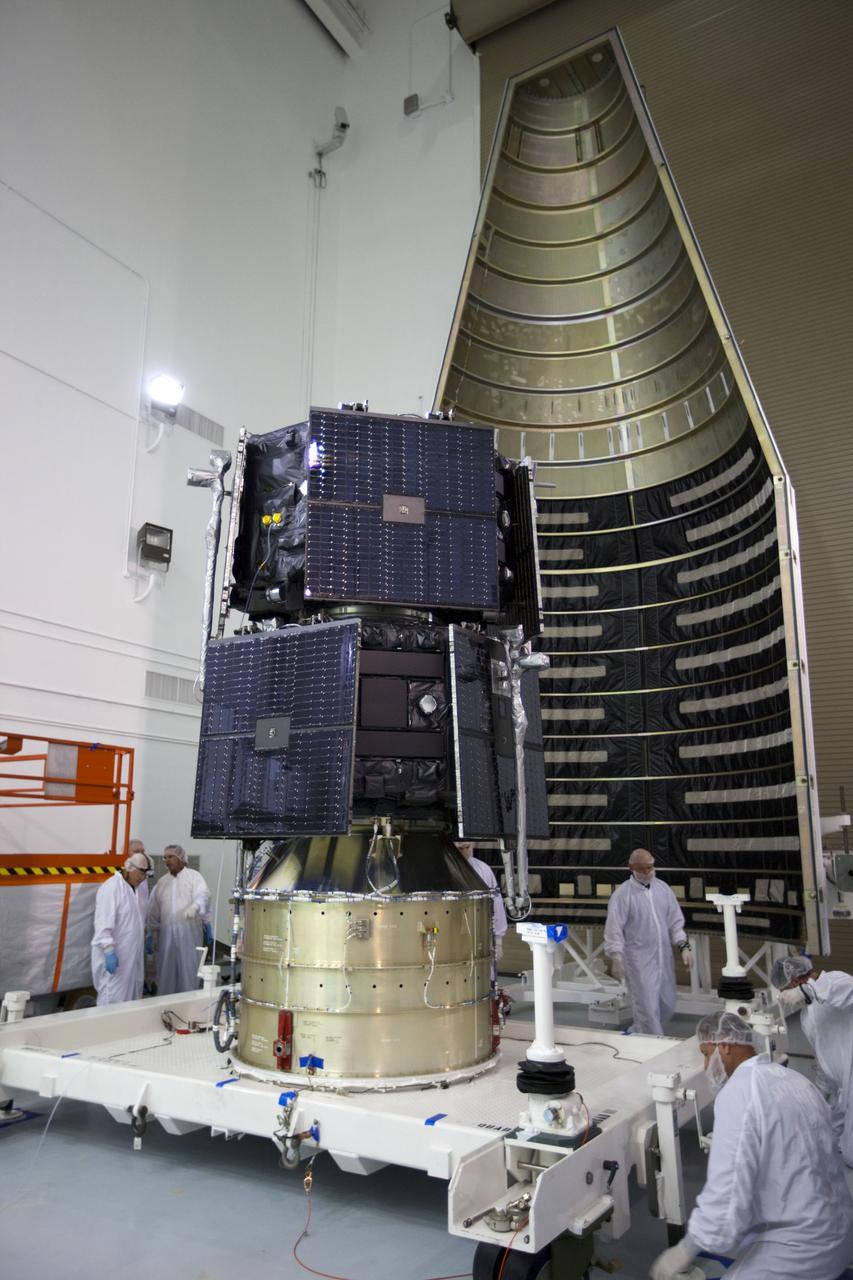 TITUSVILLE, Fla. - Inside the Astrotech payload processing facility in Titusville, Fla. near NASA’s Kennedy Space Center, technicians move the two Radiation Belt Storm Probes, or RBSP, spacecraft into position for encapsulation in the payload faring. The fairing will house and protect the RBSP during liftoff and flight through the atmosphere aboard an Atlas V rocket. NASA’s RBSP mission will help us understand the sun’s influence on Earth and near-Earth space by studying the Earth’s radiation belts on various scales of space and time. RBSP will begin its mission of exploration of Earth’s Van Allen radiation belts and the extremes of space weather after its liftoff aboard a United Launch Alliance Atlas V from Space Launch Complex 41 at Cape Canaveral Air Force Station, Fla. Liftoff is targeted for Aug. 23, 2012. For more information, visit http://www.nasa.gov/rbsp. Photo credit: NASA/ Kim Shiflett