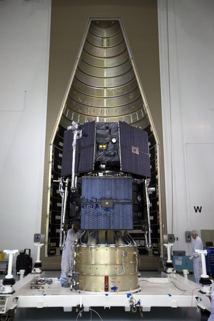TITUSVILLE, Fla. - Inside the Astrotech payload processing facility in Titusville, Fla. near NASA’s Kennedy Space Center, a technician checks out the two Radiation Belt Storm Probes, or RBSP, spacecraft as they are being encapsulated in the payload faring. The fairing will house and protect the RBSP during liftoff and flight through the atmosphere aboard an Atlas V rocket. NASA’s RBSP mission will help us understand the sun’s influence on Earth and near-Earth space by studying the Earth’s radiation belts on various scales of space and time. RBSP will begin its mission of exploration of Earth’s Van Allen radiation belts and the extremes of space weather after its liftoff aboard a United Launch Alliance Atlas V from Space Launch Complex 41 at Cape Canaveral Air Force Station, Fla. Liftoff is targeted for Aug. 23, 2012. For more information, visit http://www.nasa.gov/rbsp. Photo credit: NASA/ Kim Shiflett