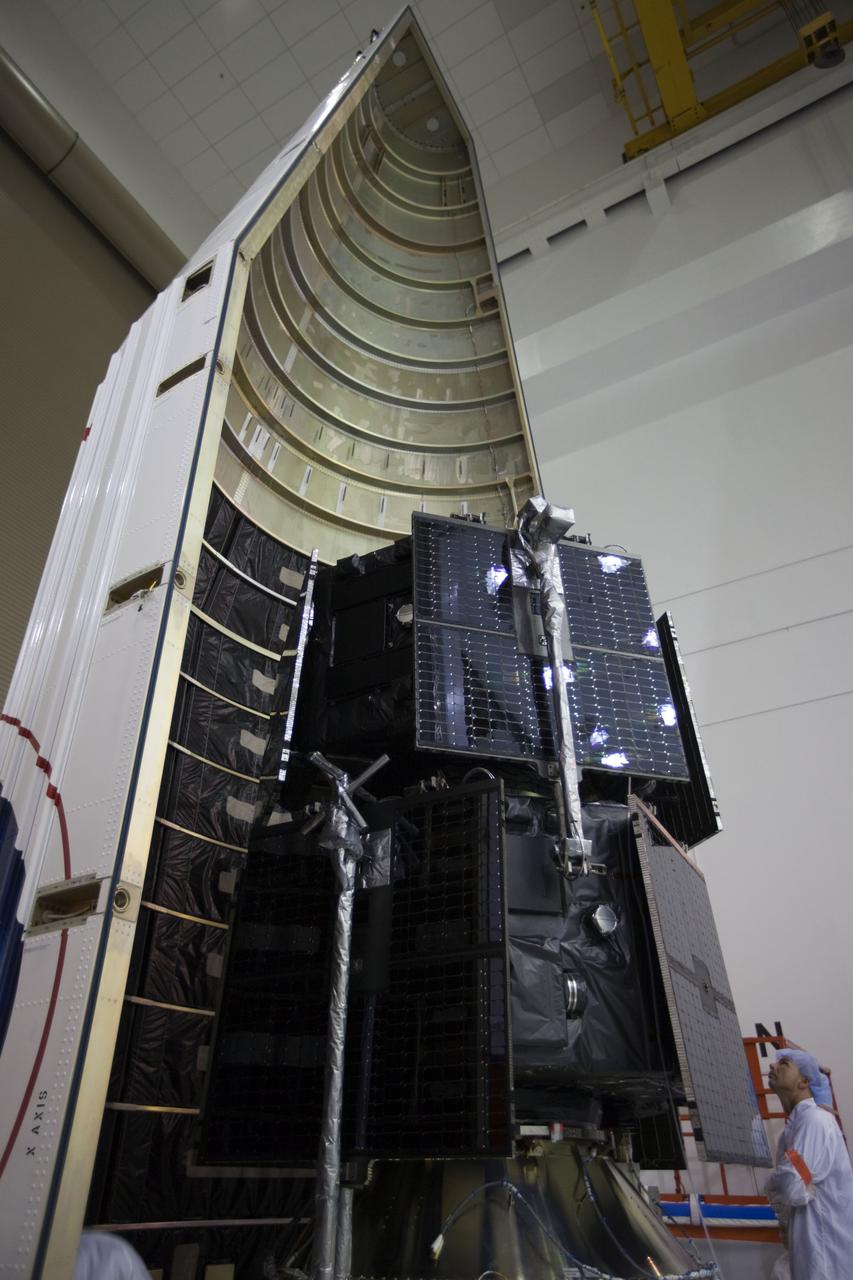 TITUSVILLE, Fla. - Inside the Astrotech payload processing facility in Titusville, Fla. near NASA’s Kennedy Space Center, a technician checks out the two Radiation Belt Storm Probes, or RBSP, spacecraft as they are being encapsulated in the payload faring. The fairing will house and protect the RBSP during liftoff and flight through the atmosphere aboard an Atlas V rocket. NASA’s RBSP mission will help us understand the sun’s influence on Earth and near-Earth space by studying the Earth’s radiation belts on various scales of space and time. RBSP will begin its mission of exploration of Earth’s Van Allen radiation belts and the extremes of space weather after its liftoff aboard a United Launch Alliance Atlas V from Space Launch Complex 41 at Cape Canaveral Air Force Station, Fla. Liftoff is targeted for Aug. 23, 2012. For more information, visit http://www.nasa.gov/rbsp. Photo credit: NASA/ Kim Shiflett
