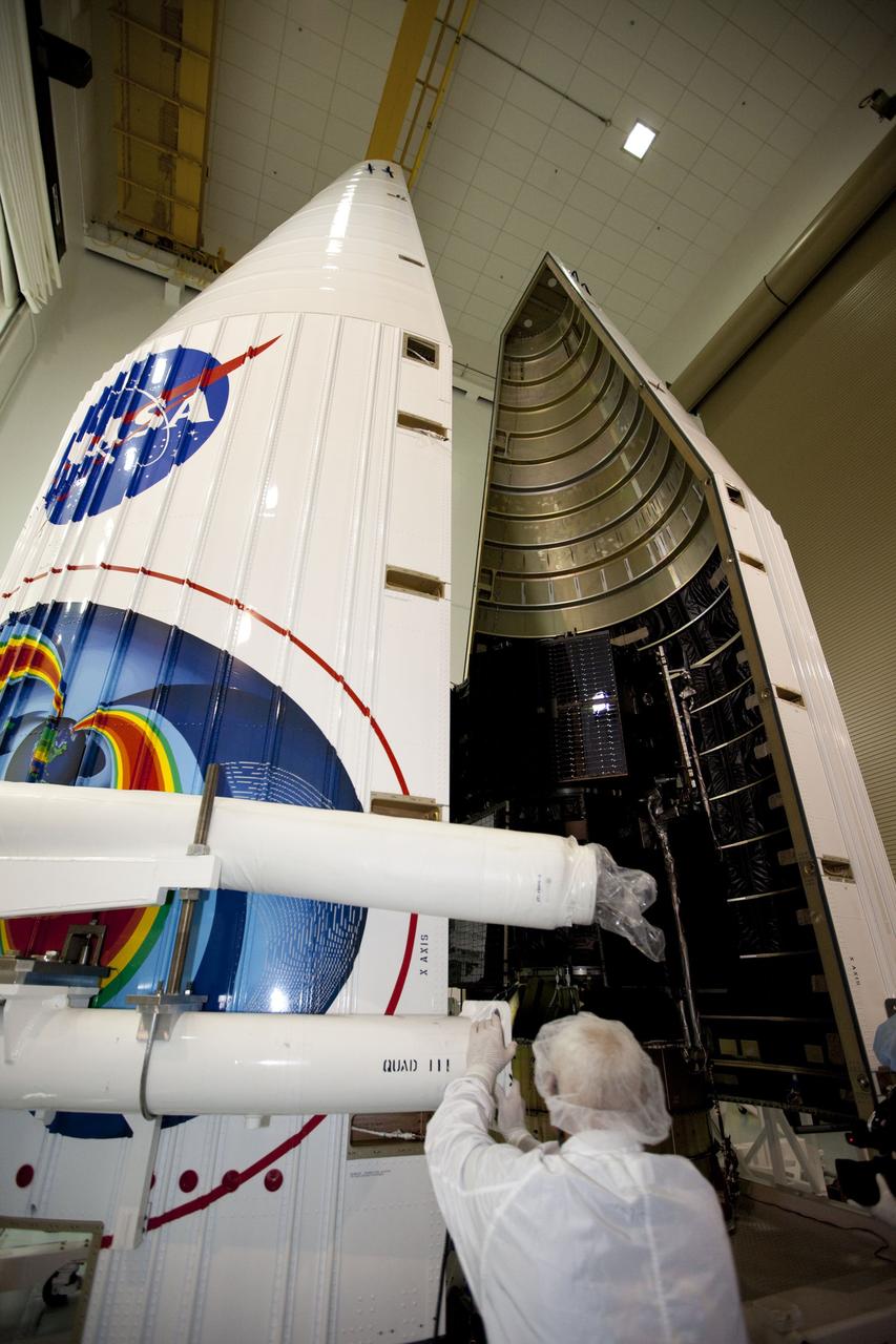 TITUSVILLE, Fla. - Inside the Astrotech payload processing facility in Titusville, Fla. near NASA’s Kennedy Space Center, technicians move the payload faring into position for encapsulation with the two Radiation Belt Storm Probes, or RBSP, spacecraft. The fairing will house and protect the RBSP during liftoff and flight through the atmosphere aboard an Atlas V rocket. NASA’s RBSP mission will help us understand the sun’s influence on Earth and near-Earth space by studying the Earth’s radiation belts on various scales of space and time. RBSP will begin its mission of exploration of Earth’s Van Allen radiation belts and the extremes of space weather after its liftoff aboard a United Launch Alliance Atlas V from Space Launch Complex 41 at Cape Canaveral Air Force Station, Fla. Liftoff is targeted for Aug. 23, 2012. For more information, visit http://www.nasa.gov/rbsp. Photo credit: NASA/ Kim Shiflett