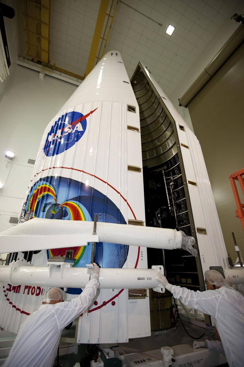 TITUSVILLE, Fla. - Inside the Astrotech payload processing facility in Titusville, Fla. near NASA’s Kennedy Space Center, technicians move the payload faring into position for encapsulation with the two Radiation Belt Storm Probes, or RBSP, spacecraft. The fairing will house and protect the RBSP during liftoff and flight through the atmosphere aboard an Atlas V rocket. NASA’s RBSP mission will help us understand the sun’s influence on Earth and near-Earth space by studying the Earth’s radiation belts on various scales of space and time. RBSP will begin its mission of exploration of Earth’s Van Allen radiation belts and the extremes of space weather after its liftoff aboard a United Launch Alliance Atlas V from Space Launch Complex 41 at Cape Canaveral Air Force Station, Fla. Liftoff is targeted for Aug. 23, 2012. For more information, visit http://www.nasa.gov/rbsp. Photo credit: NASA/ Kim Shiflett