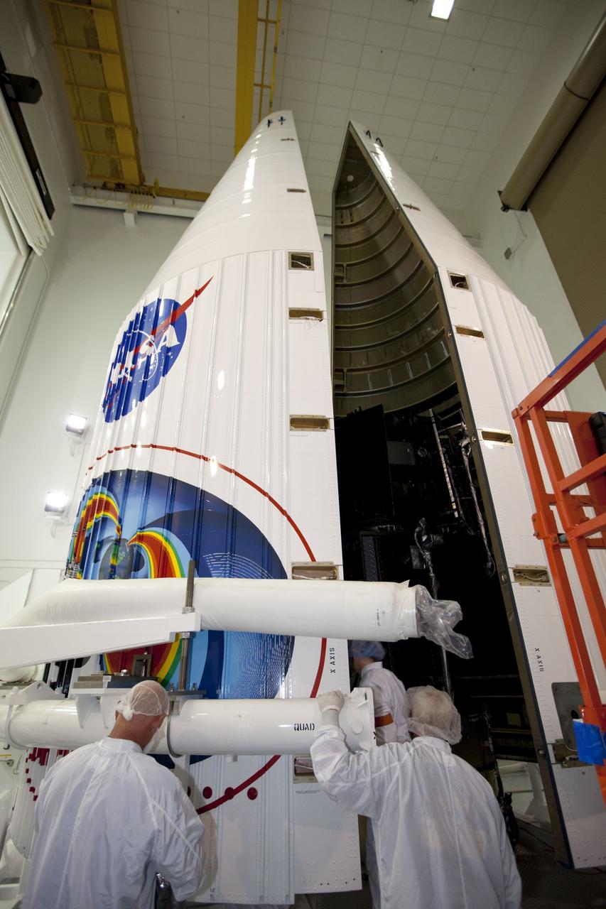 TITUSVILLE, Fla. - Inside the Astrotech payload processing facility in Titusville, Fla. near NASA’s Kennedy Space Center, technicians move the payload faring into position for encapsulation with the two Radiation Belt Storm Probes, or RBSP, spacecraft. The fairing will house and protect the RBSP during liftoff and flight through the atmosphere aboard an Atlas V rocket. NASA’s RBSP mission will help us understand the sun’s influence on Earth and near-Earth space by studying the Earth’s radiation belts on various scales of space and time. RBSP will begin its mission of exploration of Earth’s Van Allen radiation belts and the extremes of space weather after its liftoff aboard a United Launch Alliance Atlas V from Space Launch Complex 41 at Cape Canaveral Air Force Station, Fla. Liftoff is targeted for Aug. 23, 2012. For more information, visit http://www.nasa.gov/rbsp. Photo credit: NASA/ Kim Shiflett