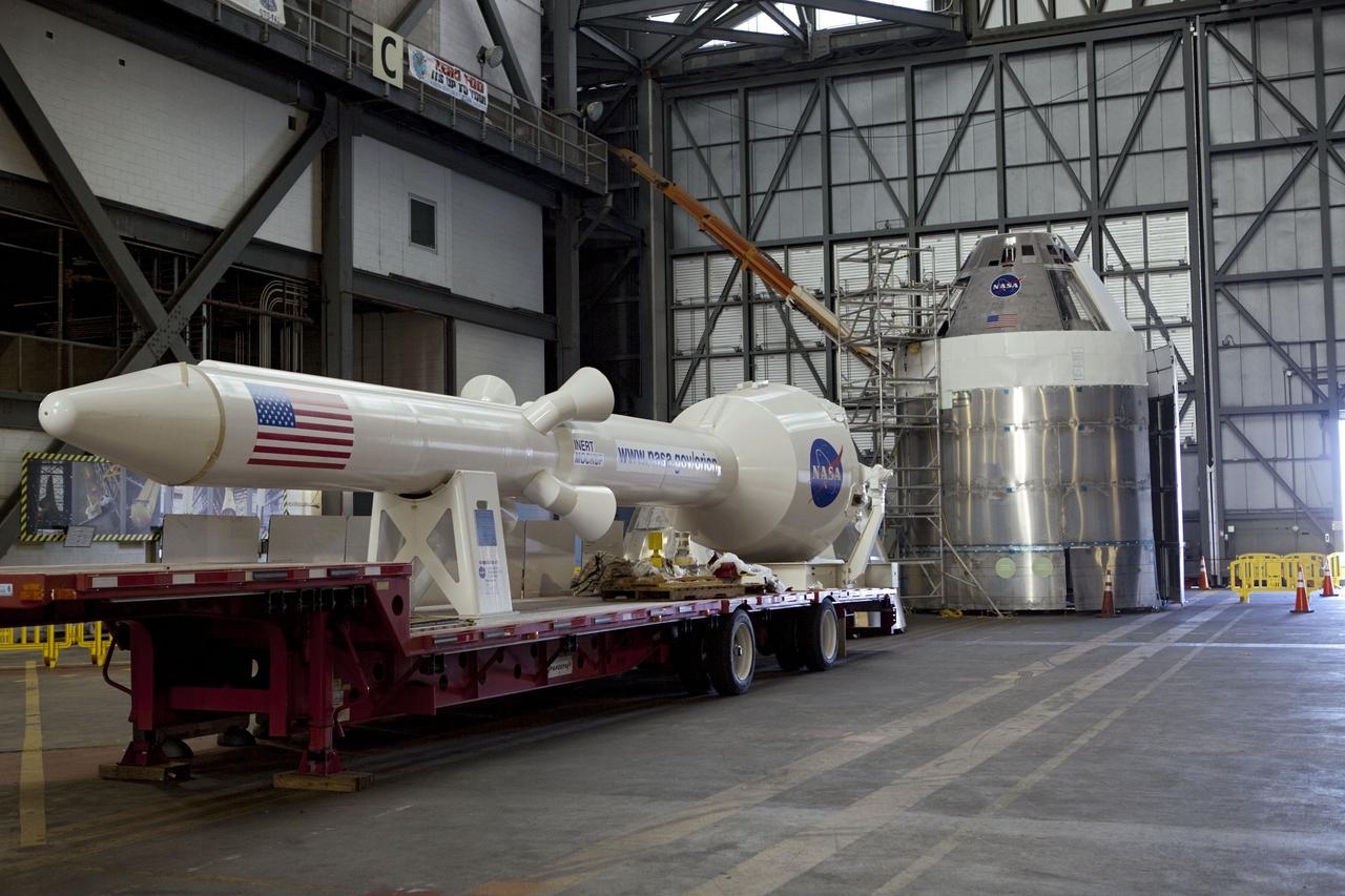 CAPE CANAVERAL, Fla. – Mockup components of an Orion spacecraft are laid out in the transfer aisle of the Vehicle Assembly Building, or VAB, at NASA's Kennedy Space Center in Florida. In the foreground is the Launch Abort System. In the background is the Orion capsule model on top of a service module simulator. Orion is the exploration spacecraft designed to carry crews to space beyond low Earth orbit. It will provide emergency abort capability, sustain the crew during the space travel and provide safe re-entry from deep space return velocities. The first uncrewed test flight of the Orion is scheduled to launch in 2014 atop a Delta IV rocket and in 2017 on a Space Launch System rocket. The Orion mockup is exact in details on the outside, but mostly empty on the inside except for four mockup astronaut seats and hatch. The work in the VAB is crucial to making sure the designs are accurate. For more information, visit http://www.nasa.gov/orion Photo credit: NASA/ Dmitri Gerondidakis