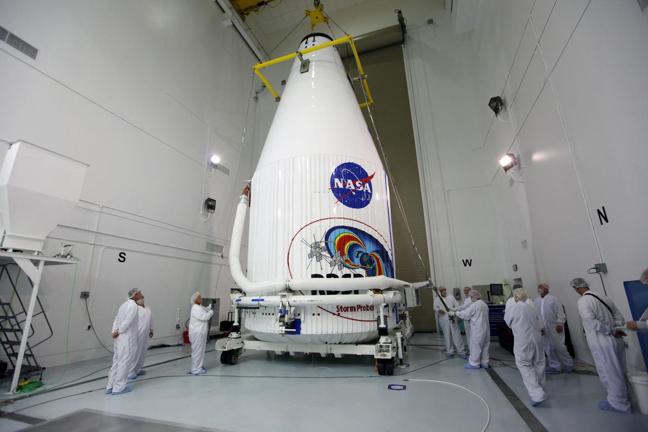 TITUSVILLE, Fla. - Inside the Astrotech payload processing facility in Titusville, Fla. near NASA’s Kennedy Space Center, technicians attach a crane to lift the payload faring containing the two Radiation Belt Storm Probes, or RBSP, spacecraft on to a transporter to be moved to the launch complex. NASA’s RBSP mission will help us understand the sun’s influence on Earth and near-Earth space by studying the Earth’s radiation belts on various scales of space and time. RBSP will begin its mission of exploration of Earth’s Van Allen radiation belts and the extremes of space weather after its liftoff aboard a United Launch Alliance Atlas V rocket from Space Launch Complex 41 at Cape Canaveral Air Force Station, Fla. Liftoff is targeted for Aug. 23, 2012. For more information, visit http://www.nasa.gov/rbsp Photo credit: NASA/ Kim Shiflett