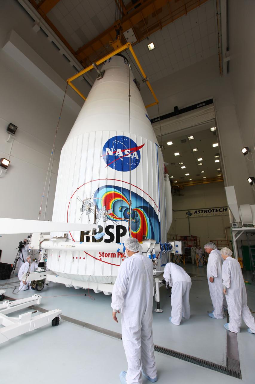 TITUSVILLE, Fla. - Inside the Astrotech payload processing facility in Titusville, Fla. near NASA’s Kennedy Space Center, technicians attach a crane to lift the payload faring containing the two Radiation Belt Storm Probes, or RBSP, spacecraft on to a transporter to be moved to the launch complex. NASA’s RBSP mission will help us understand the sun’s influence on Earth and near-Earth space by studying the Earth’s radiation belts on various scales of space and time. RBSP will begin its mission of exploration of Earth’s Van Allen radiation belts and the extremes of space weather after its liftoff aboard a United Launch Alliance Atlas V rocket from Space Launch Complex 41 at Cape Canaveral Air Force Station, Fla. Liftoff is targeted for Aug. 23, 2012. For more information, visit http://www.nasa.gov/rbsp Photo credit: NASA/ Kim Shiflett